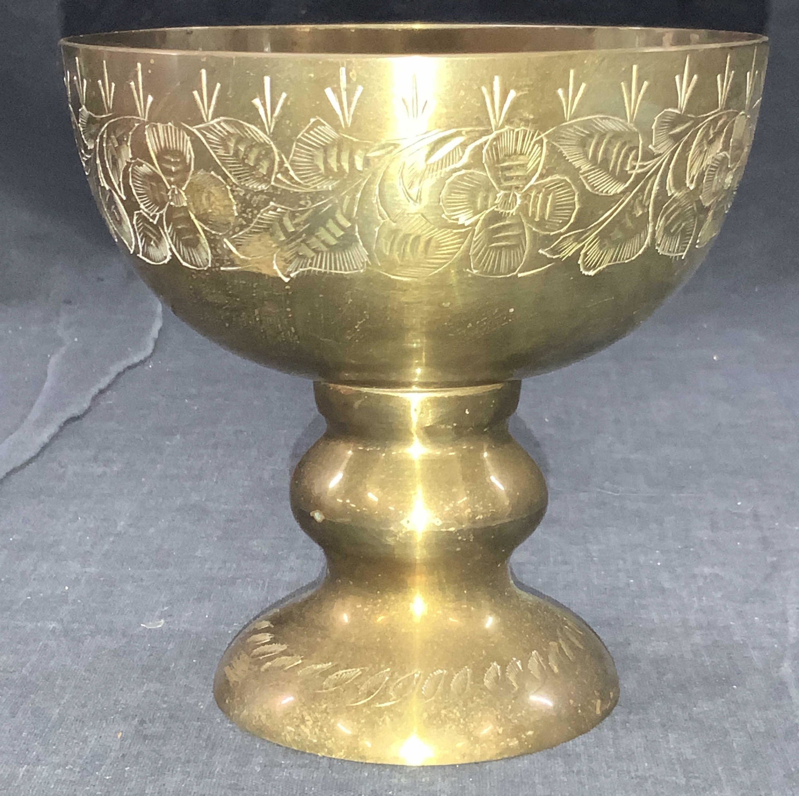 Vintage Etched & Cast Brass Goblet, India: Vintage cast brass goblet. Etched on exterior with floral motifs and etched on vase with leaves. Approximately 5 inches tall. Marked on underside Made in India, W1551. Minor wearing to brass. Vintage 