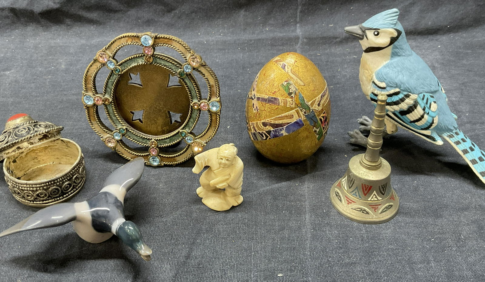 Lot 7 Miscellaneous Objects, Metal & More: Lot 7 Miscellaneous Objects, Metal & More. Includes Blue Jay Composite figural, round miniature frame, carved bone Asian Figural, decoupage egg, bell, porcelain Duck Figural and a silver toned trinket