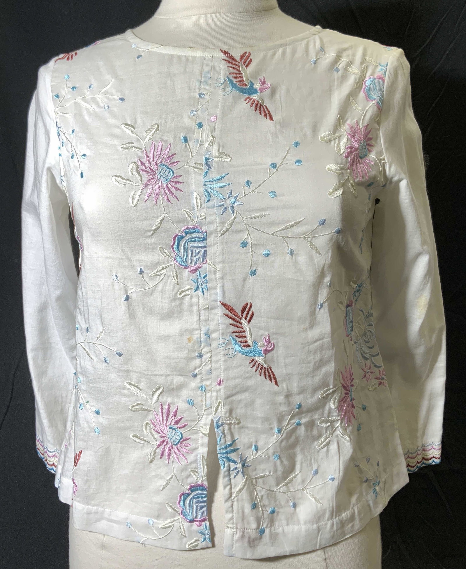 CUSTOC White Floral Embroidered Blouse: CUSTOC white cotton blouse with floral and bird motif embroidery. Size S. Some blemishes to fabric. CUSTOC, CUSTOC blouse, ladies designer blouse, ladies designer fashion, ladies embroidered blouse, l