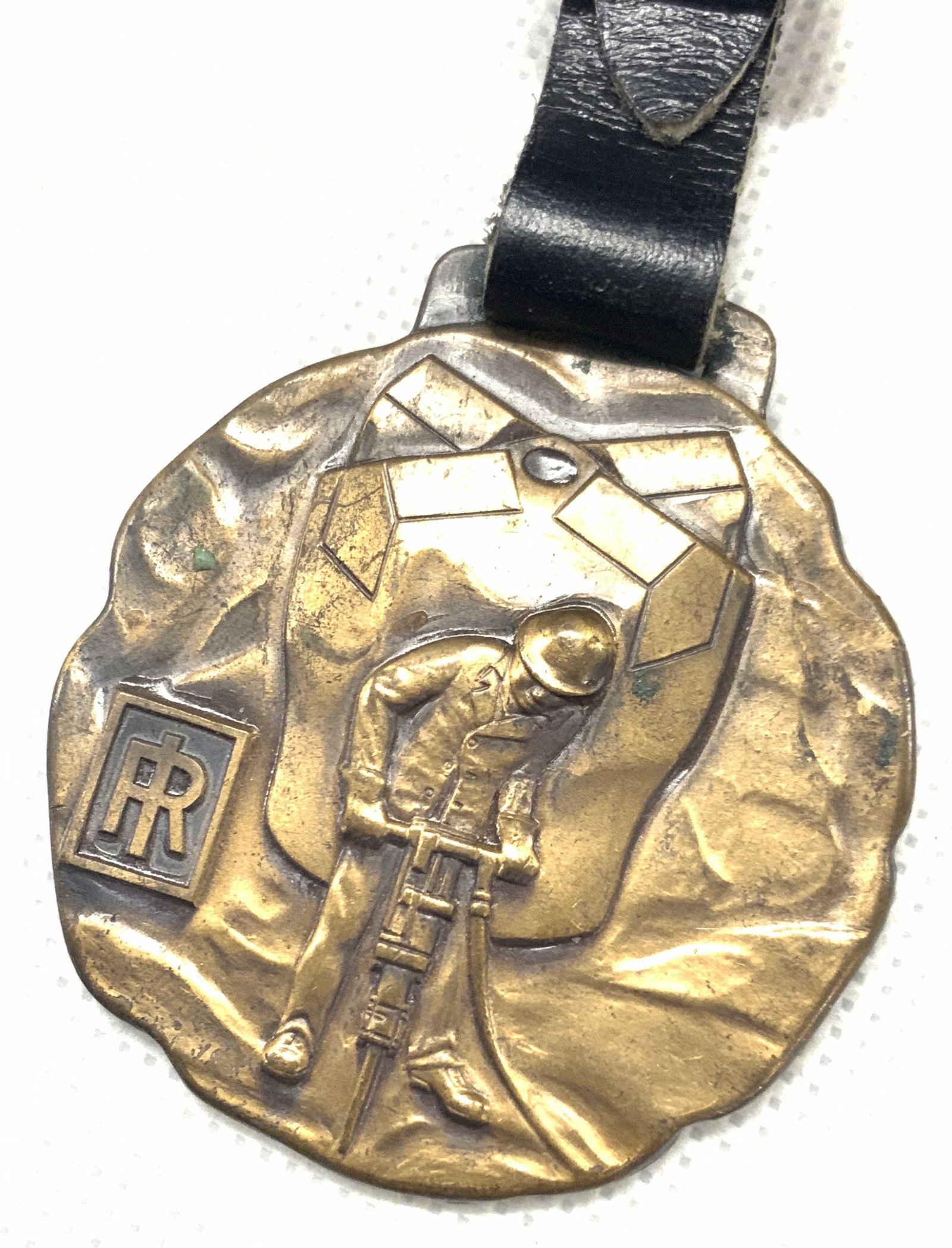 Ingersoll-Rand Jackbits Copper Medallion: Copper medallion attached to black leather strap. Medal depicts a worker using a jackhammer with the logo IR on the corner. Backside reads, Ingersoll - Rand. Broadway, New York City. carset, Jackbits.