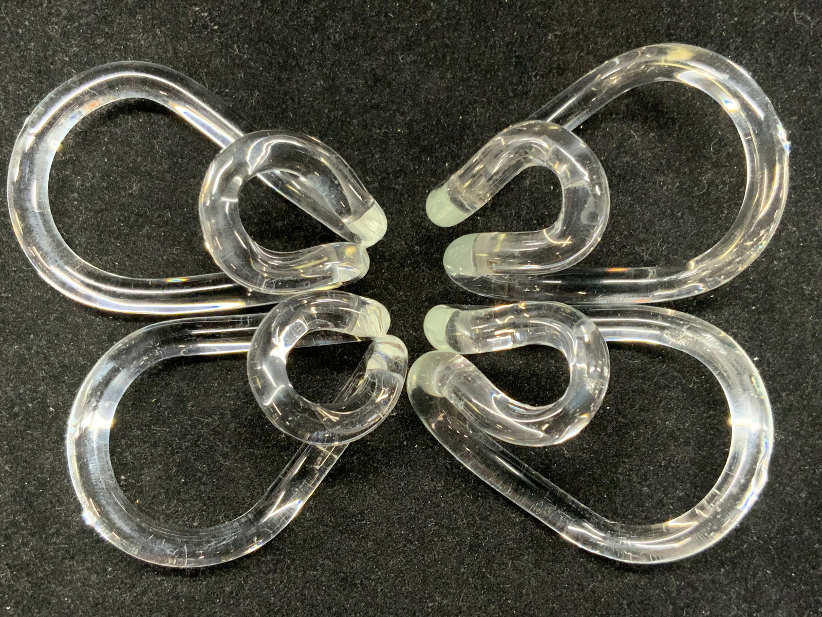 Vintage Clear Glass Napkin Rings: 4 clear glass napkin rings. Varying in sizes of 2.5 - 3 inches long. Both sets are curved single rings of blown glass. Packaged in bubble wrap and in plastic bag. Vintage napkin holders, blown glass a