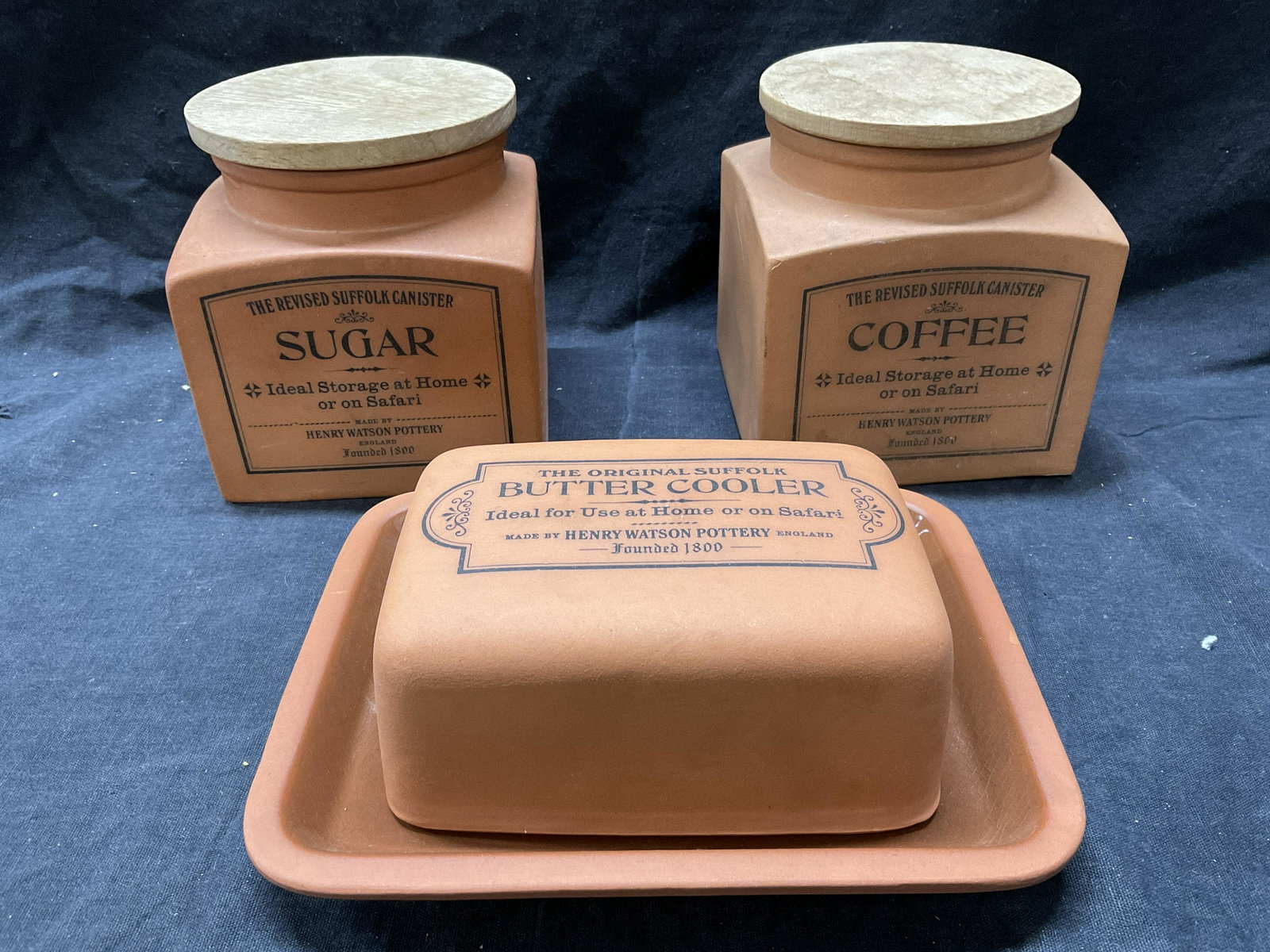 Lot 3 The Revised Suffolk Canisters: 3 The Revised Suffolk Canisters for Coffee, Sugar, and Butter. Largest measures 7.25 x 5.25 inches. Coffee seal needs replacement. Labeled ‘Ideal storage at home or on Safari’. Wear to pieces are 