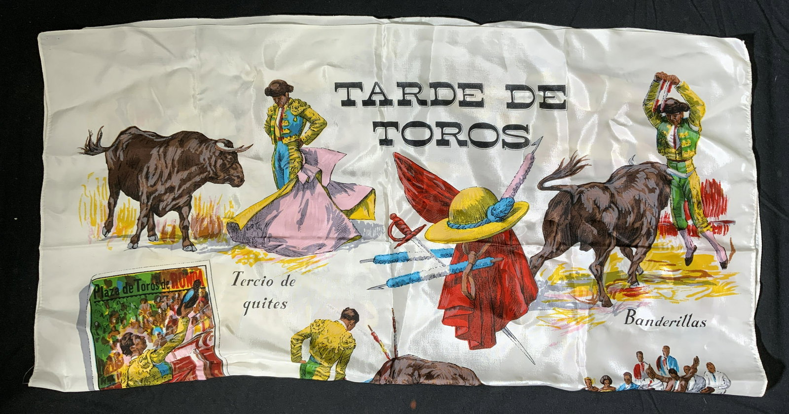 Tarde De Toros Bullfighting Scarf: Tarde de Toros bullfighting motif scarf. Multi color white scarf with various images of matadors and bulls. Measures approx. 29 x 30 inches. Material feels like synthetic, possibly polyester. Property