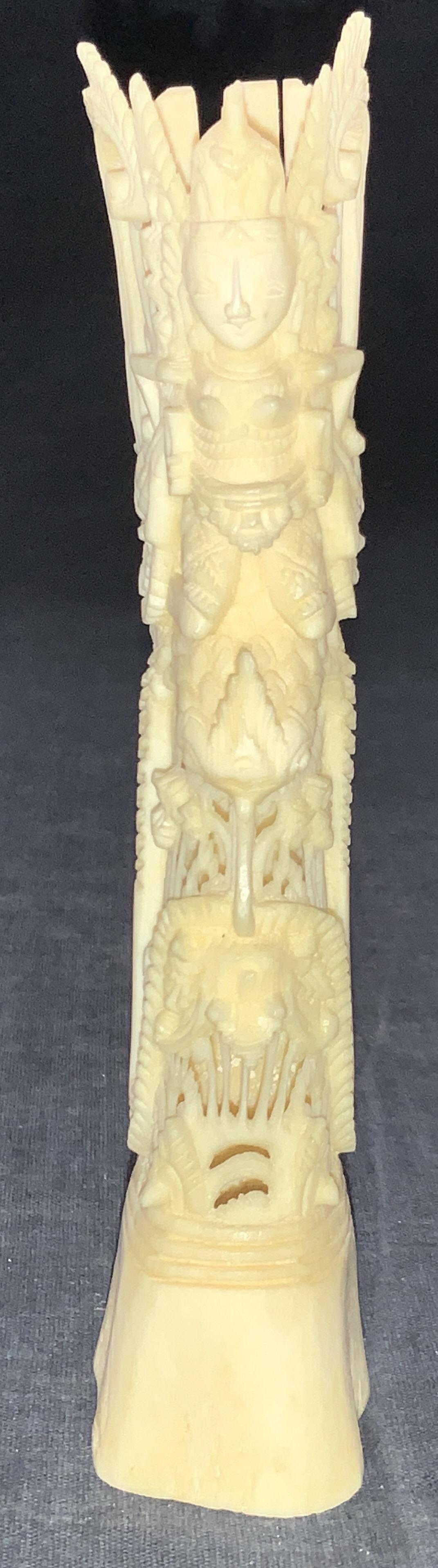 Vintage Carved Bone Balinese Goddess Figurine: Vintage hand carved bone depicting Balinese goddess atop a serpent creature with other mythological motifs throughout. Approximately 6 inches tall. Minor loss to top. Vintage carved bone, carved bone,
