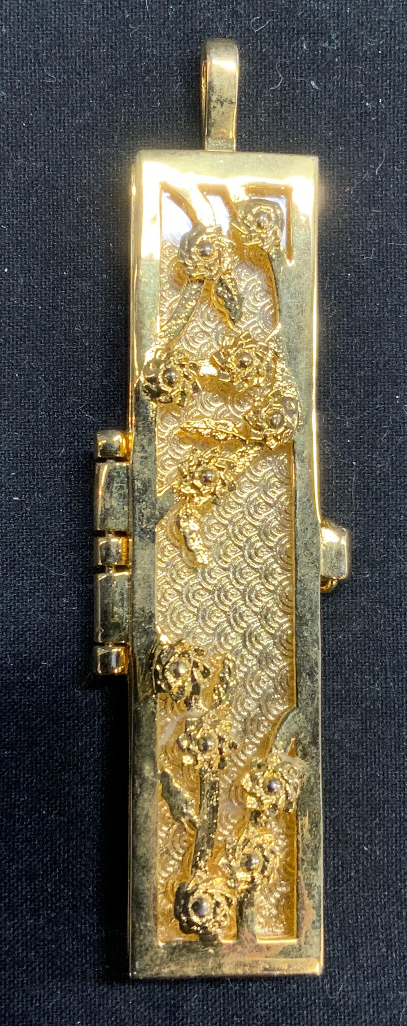 Vintage Gold Tone Floral Locket Pendant: Vintage gold tone locket pendant with floral motif. Reads ‘your fortune is within to side. Measures approx. 2.5 x .5 inches. Surface wear consistent with exposure. Vintage jewelry, costume jewelry, 