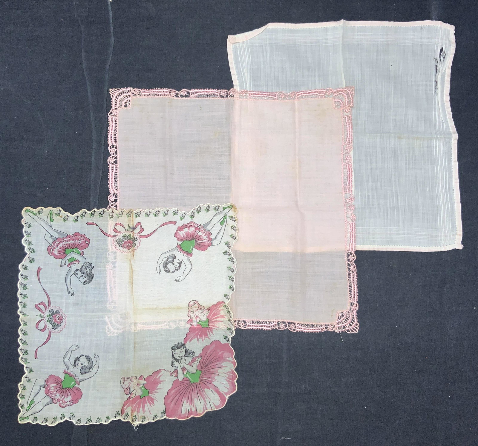 3 Vintage Embroidered Illustrated Handkerchiefs: 3 vintage handkerchiefs, 1 starch white, 1 pink with embroidered edges and 1 illustrated handkerchief with images of ballerinas in pink and green tutus resembling flowers with white rose motifs on the