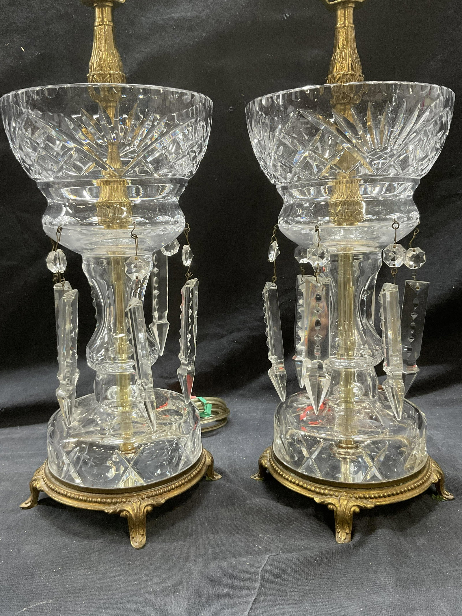 Pair Crystal Cut Side Table Lamps: Pair Crystal Cut Side Table Lamps. Measures 25.5 x 6 inches. No shade & NOT tested for functionality. Crystal cut dangle decors have minimal chipping to tips. Brass detail to bottom and center. Finial