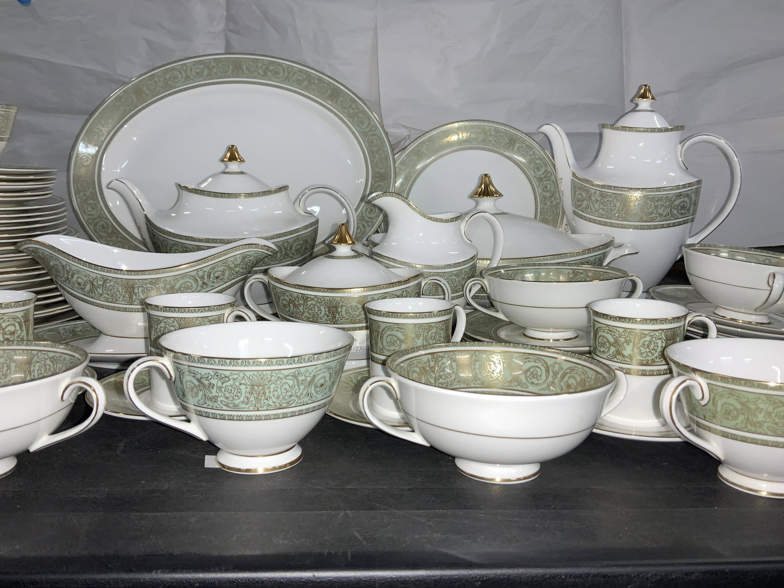 Royal Doulton English Renaissance Chinaware 68: fine bone China set, 68 pieces total including lids. Bright white with mint green borders , gilt acanthus leaves and scrolls and gilt rims and finials. Many pieces are footed. Hallmarked ROYAL DOULTON