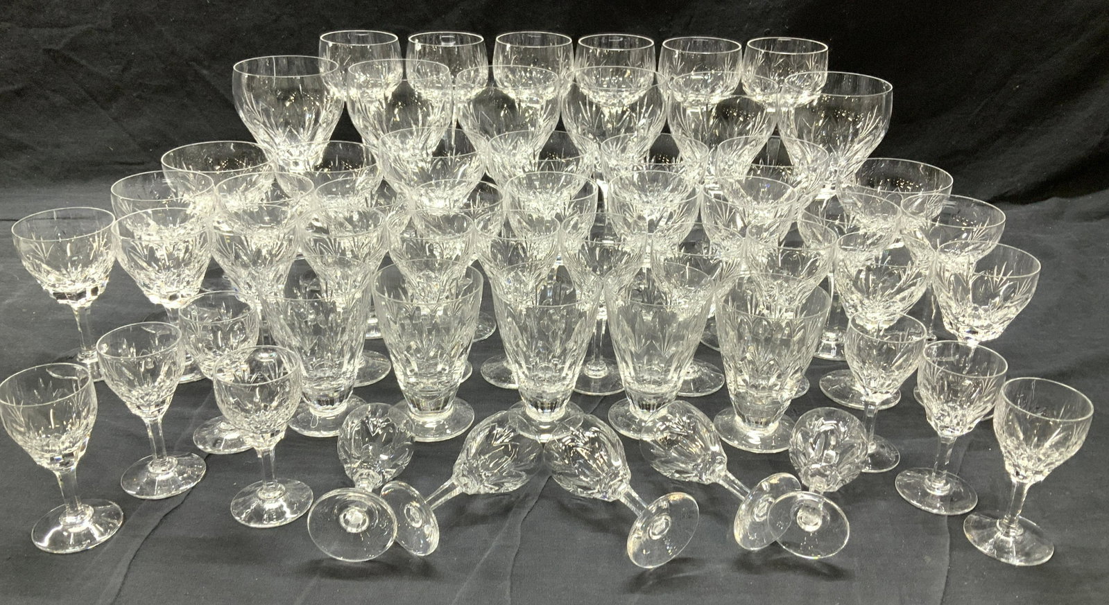 Stuart Sgn Cut Crystal Luxury Stemware Set 56: Stuart Cut glass stemware, made in England. All glasses have the same pattern, several shapes and sizes. Goblets 7 in ht., Red wine glasses 6.5 x 3.75 in. Cordials/aperitif glasses 3.5 in ht. x 1.75 i