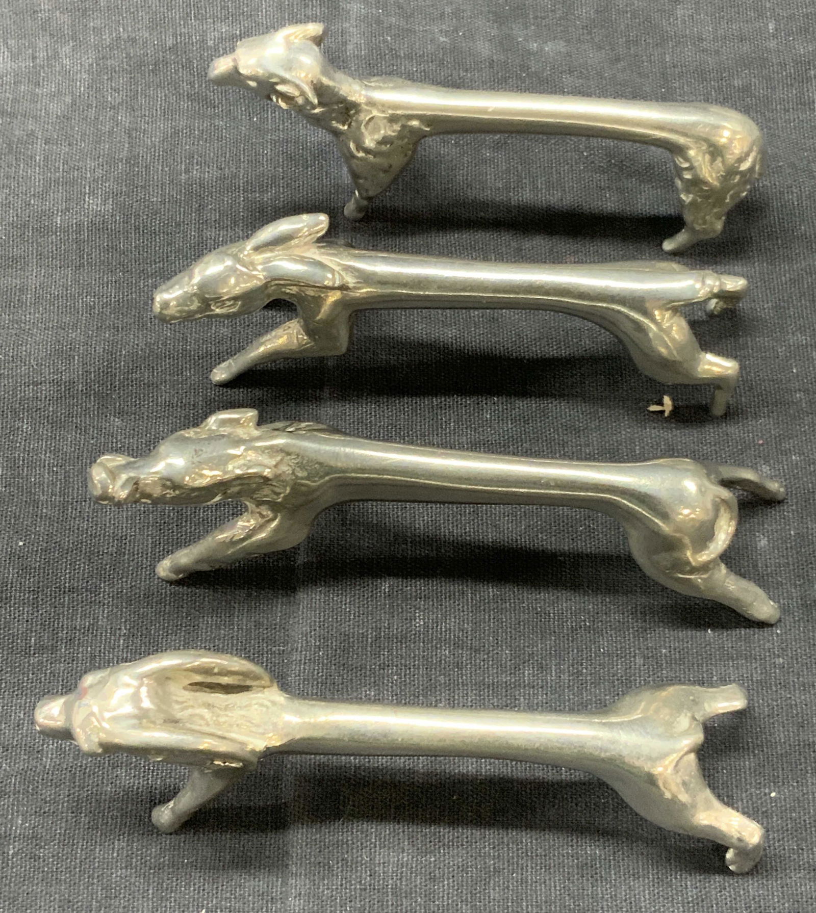 Les Etains BLAIS 4 Animal Pewter Knife Rests: Set of 4 pewter knife rests made it resemble farm animals. 1 ram, sheep, pig and rabbit. Approximately 3.5 inches long. Marked on undersides Les Etains BLAIS. Minor wearing to detail. Les Etains knife