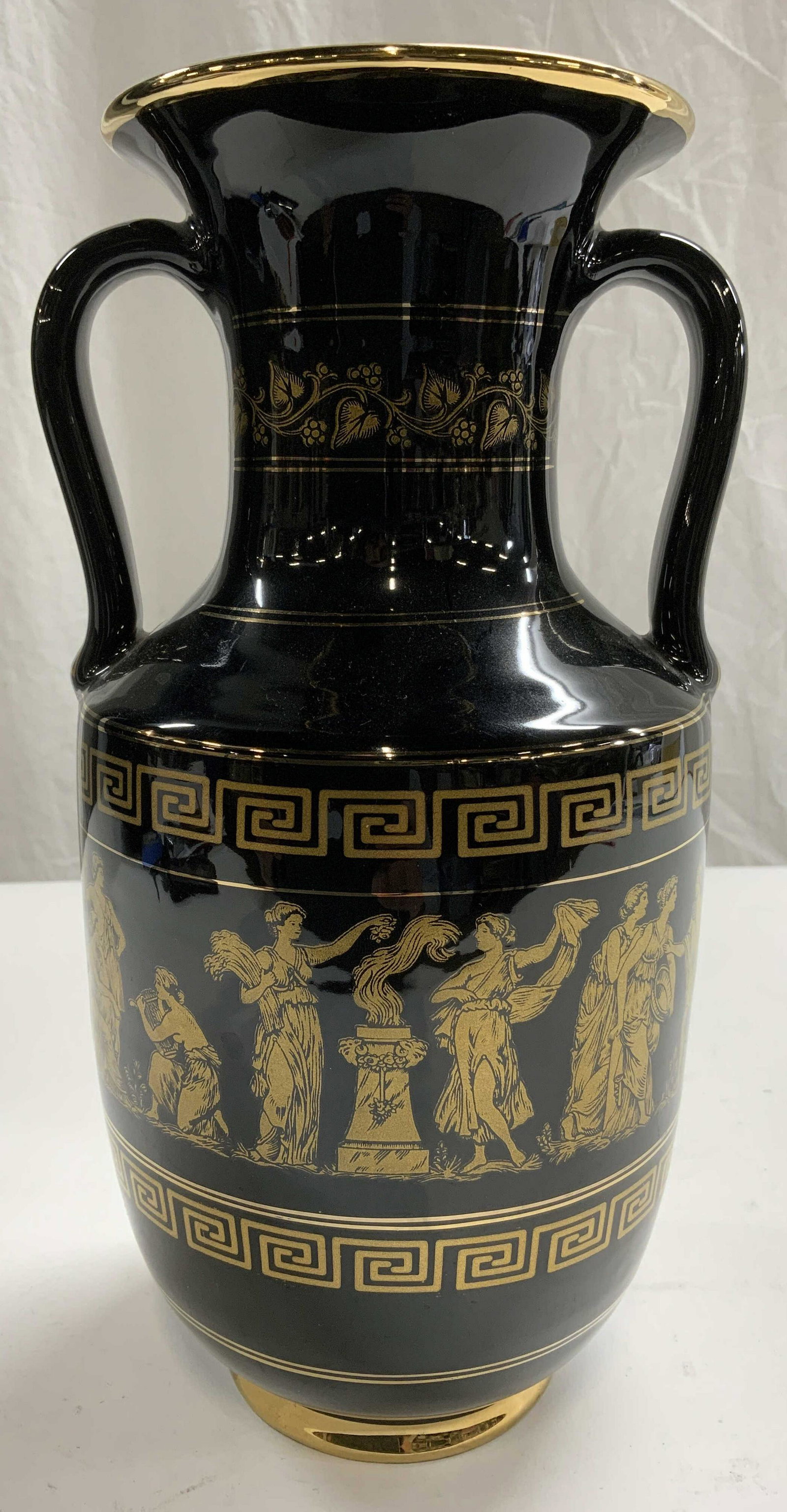 SPATHAS KERAMIK Vase W Handles GREECE: Underside is marked SPATHAS KERAMIK HAND MADE IN GREECE 24 K GOLD. Vase is black and gold toned. Piece has vine, leaf, & depictions of various figures. Vase has 2 handles. Rim is gold toned. Piece mea
