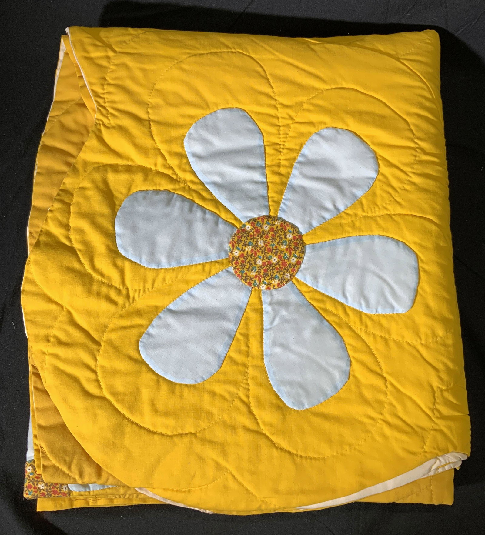 Vintage Yellow Hand Stitched Floral Applique Quilt: Vintage mid century quilt with hand stitched floral applique. Hues of yellow and blue. Vintage circa 1965. Some wear to fabric consistent with exposure. Measures approx. 83 x 85 inches. Property of Gr