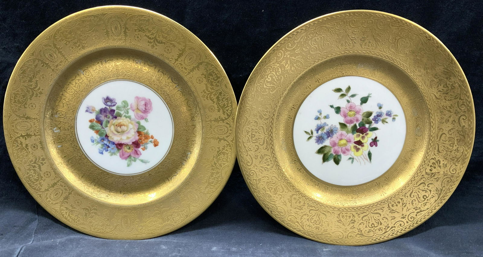 HUTSCHENREUTHER Hand Gilt Dinner Plates, 8: HUTSCHENREUTHER SELB hand painted porcelain plates with center design of florals and embossed solid 24 k gilt with scroll patterns. Gilt covers 3/4 of the plate. Plate measures 11 in. One plate has a