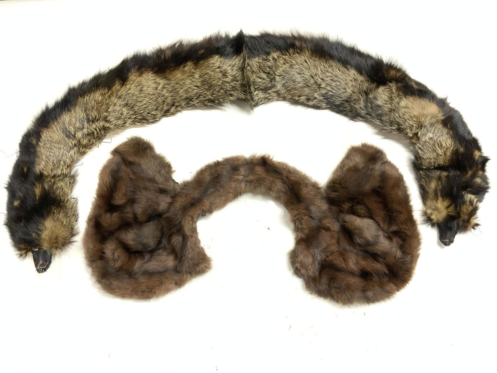 Lot 2 Mink & Ferret Shoulder Covers: 1 brown mink fur shoulder cover. Measures approx. 22 inches wide. 1 black ferret fur shoulder wrap. Measures approx. 32 inches wide. Both pieces have wear consistent with exposure. Fur, mink, ferret,