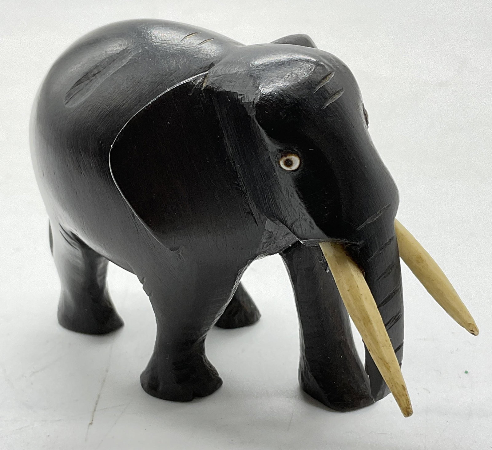 Wooden Elephant W Carved Bone Accents: Wooden Elephant. Appears to have carved bone elements, possibly faux bone. Measures approx 3.5 x 2.5 inches. Surface wear consistent with age. Elephant Figural, miniature elephant figural, wooden elep
