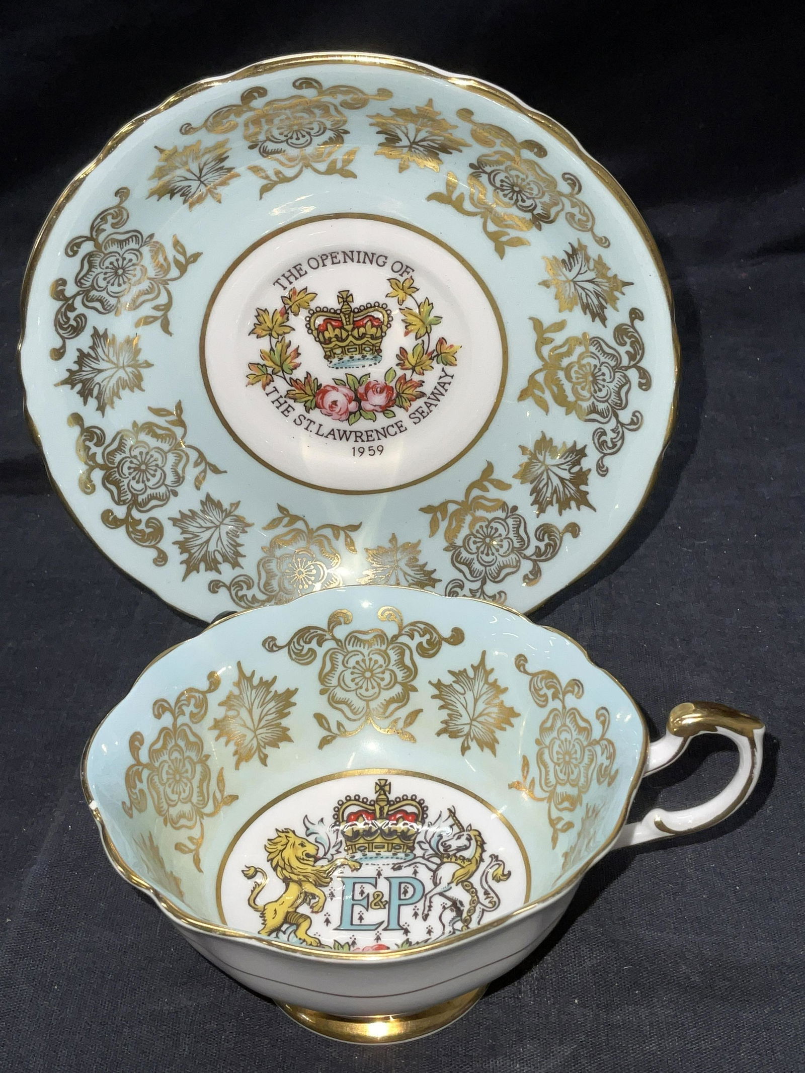 Hand Painted Fine Bone Paragon TeaCup & Saucer: Hand Painted Fine Bone Paragon Tea Cup & Saucer. Both have gilt detail to surface. Saucer reads The opening of the st Lawrence seaway 1959. Obverse of teacup reads By appointment to her majesty the Qu