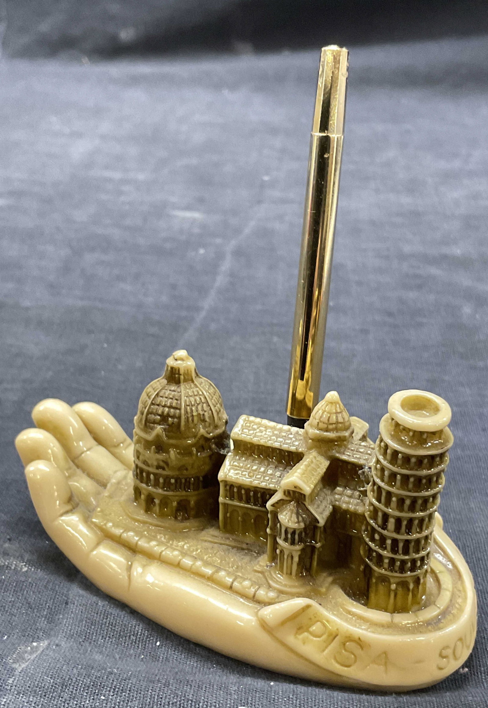 Pisa, Italy Pen Holder Resin Tabletop Accessory: Measures approx 4 x 2.25 inches. Resin mold of some architectural points in Pisa. Labeled to one side Pisa Souvenir. Pen to piece does not function, surface wear is consistent with age use. Resin mold