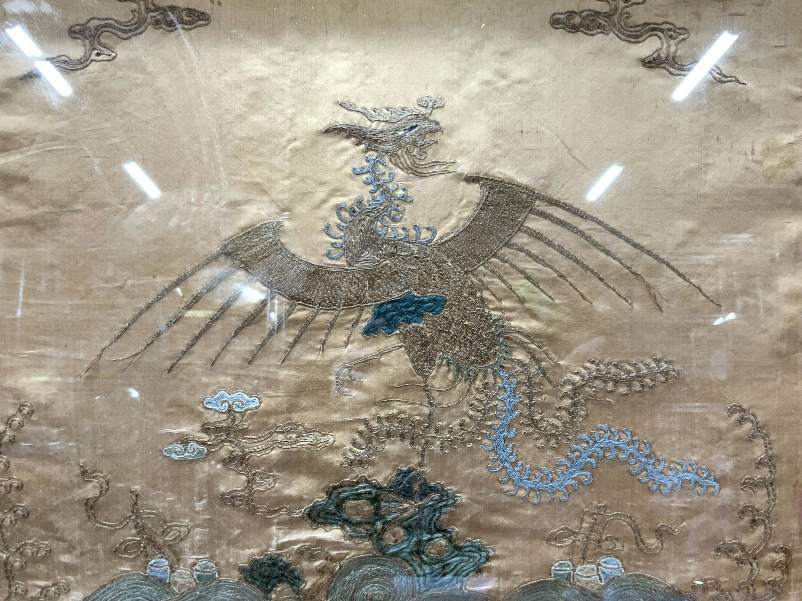 Vintage Embroidered Chinese Feng Huang Bird: Vintage embroidered panel depicting a Feng Huang, Chinese mythological bird in gold toned threading. Professionally framed in gold metal leaded wooden frame. Approximately 21 x 25 inches, window measu