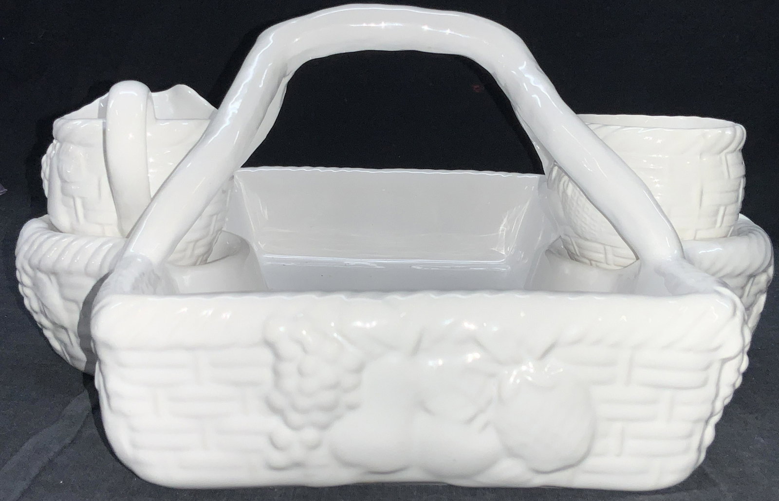 SHAFFORD Porcelain Basket Serving Set: White porcelain serving basket with side sections with sugar bowl and pitcher. Basket is made to resemble a wicker basket with floral motifs and fruit. 7 inches tall and 11 x 11 inches wide. Marked on