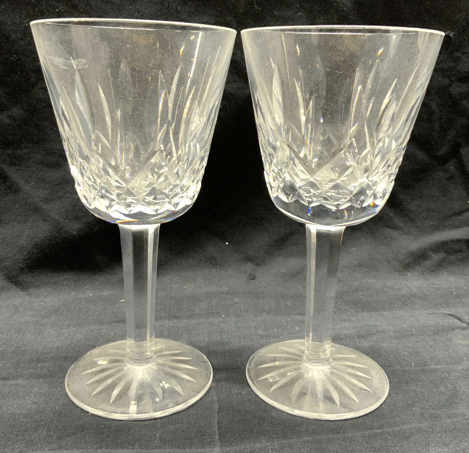 WATERFORD Pair Crystal Goblets: Undersides are marked WATERFORD. Each are cut crystal. Bases are each circular shaped. Goblets measure approx 5.75 inches tall 3 inches wide. Goblets, Waterford Crystal, Waterford goblets, stemware, b