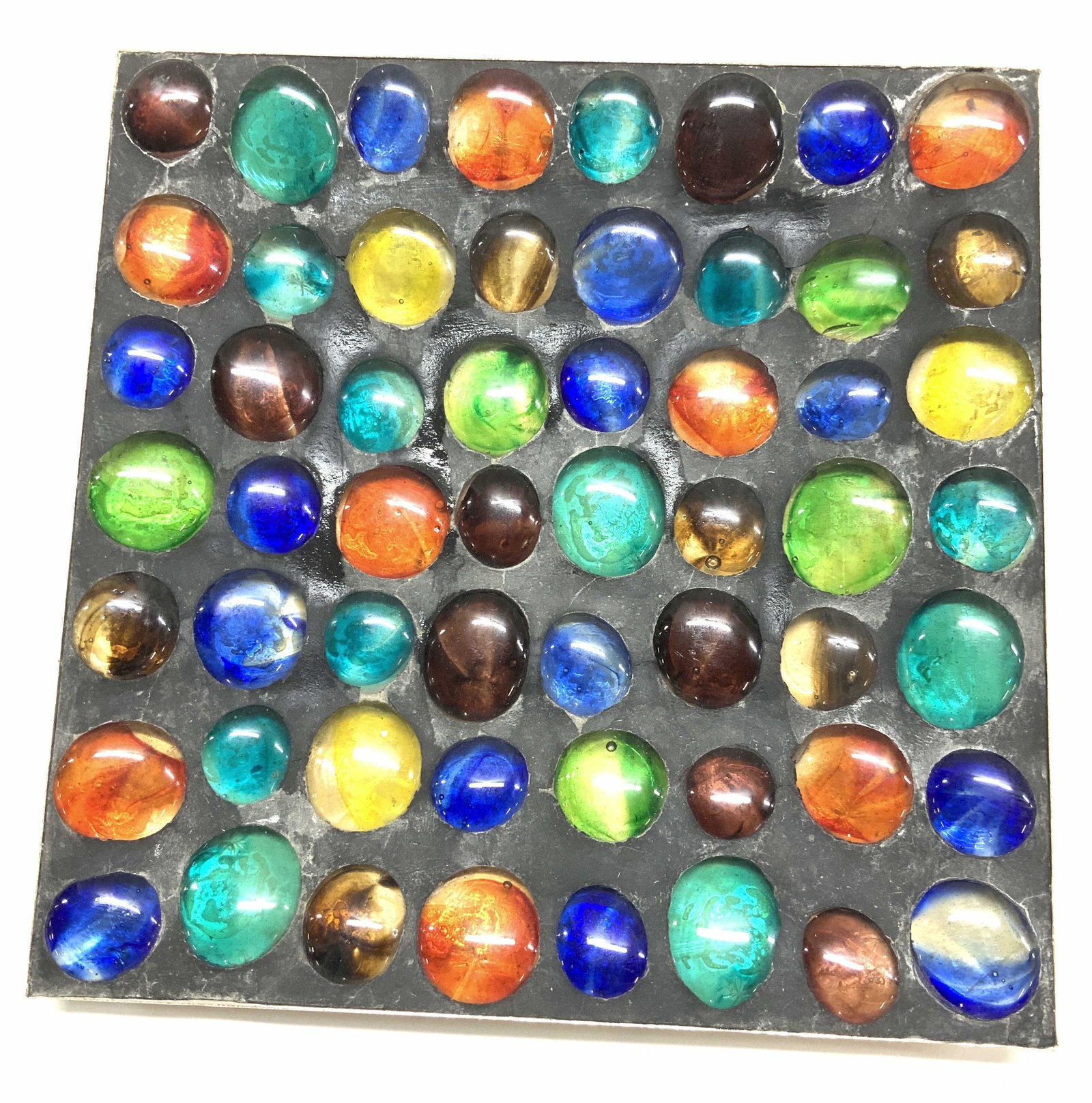 Mid Century Art Glass Cabochon Plate: Hand made decorative plate with inlaid multi chrome art glass cabochons in colors of cobalt blue, teal, orange, yellow and amethyst. Glass in inlaid in a charcoal composite putty substance set in meta