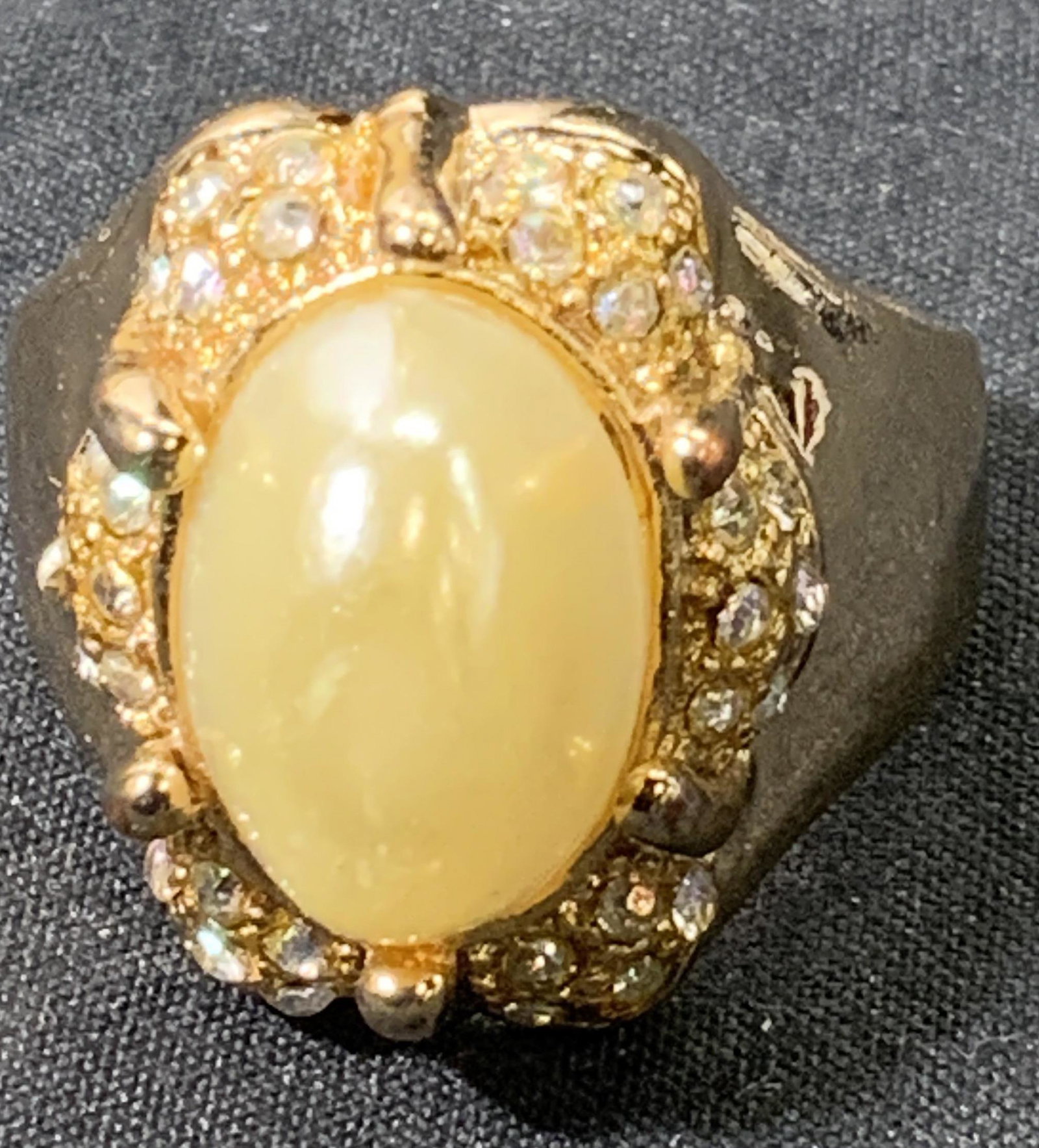Gold Tone Faux Pearl Cocktail Ring: Gold tone cocktail ring with faux Pearl to center and cooler crystal halo. Ring size 9. In good condition. Cocktail ring, chunky ring, faux Pearl ring, crystal ring, gold tone ring, ladies accessories