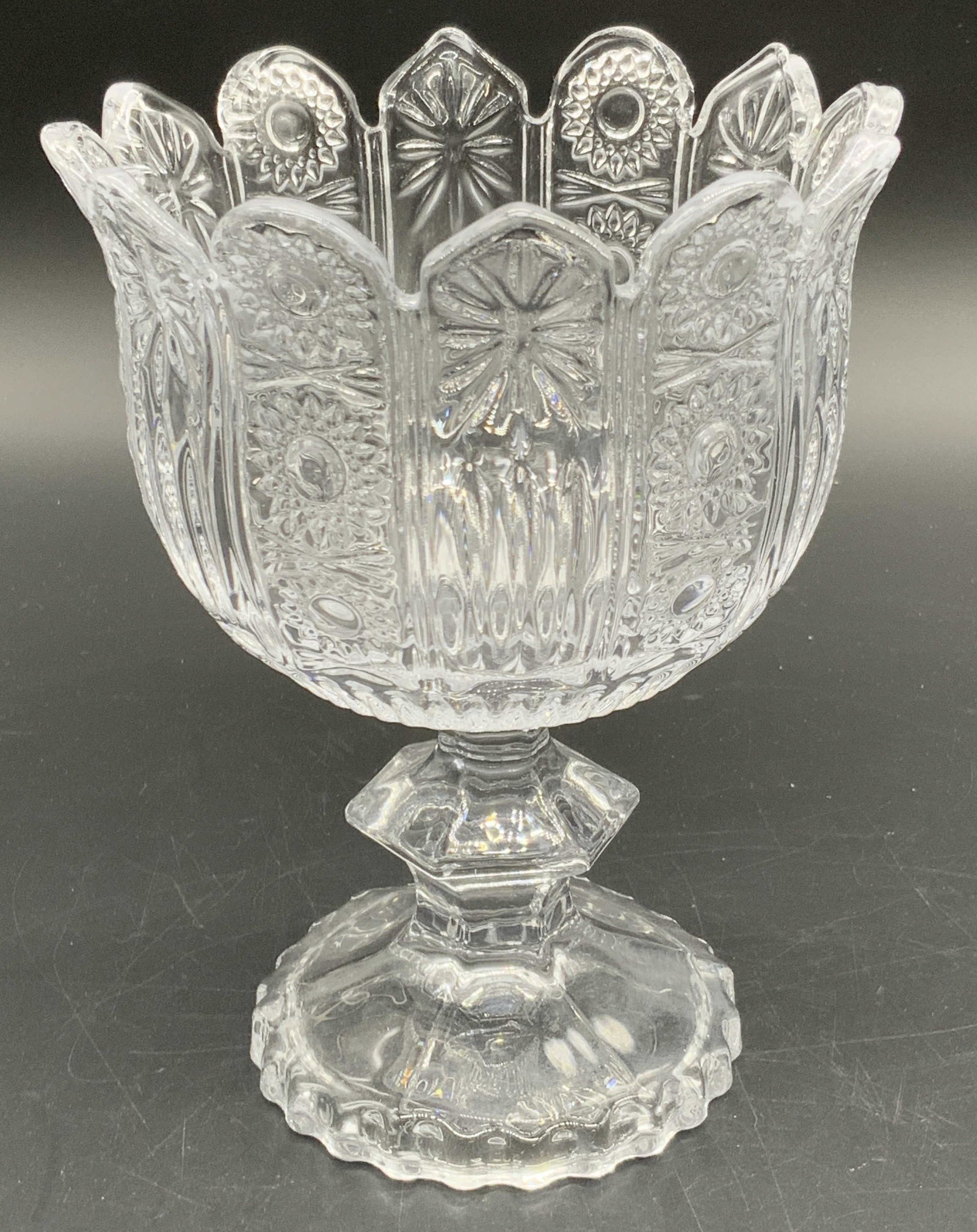 Vintage Crystal Tulip Rim Goblet / Vessel: A colorless crystal tulip rimmed goblet / vessel. Floral and burst cut crystal designs throughout. Measures approx 6H x 4.5W in. Some surface wear consistent with age and use. Crystalware, glassware, 
