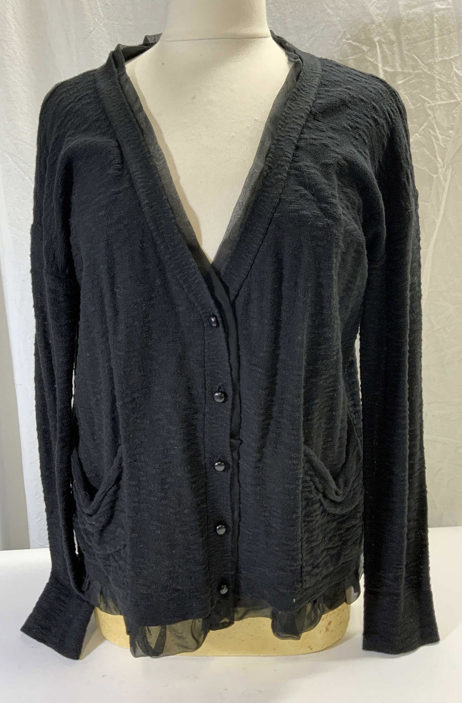 KENSIE Black Cotton Blend Cardigan: KENSIE black cardigan with front button and pockets. Measures approx. 21 inches across chest. Gently worn. Cotton and acrylic blend. Polyester trim. KENSIE, KENSIE cardigan , ladies designer cardigan,