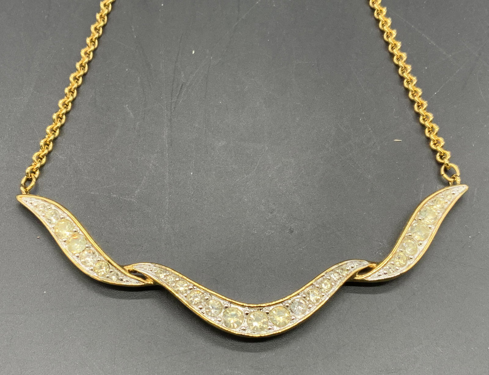 MONET Gold Tone Crystal Choker Necklace: Monet gold tone choker necklace with prong set faceted colorless crystals. Lobster claw clasp. Measures approx. 17.5 inches long. Trademarked to back of pendant. Marked to clasp, illegible. In good co