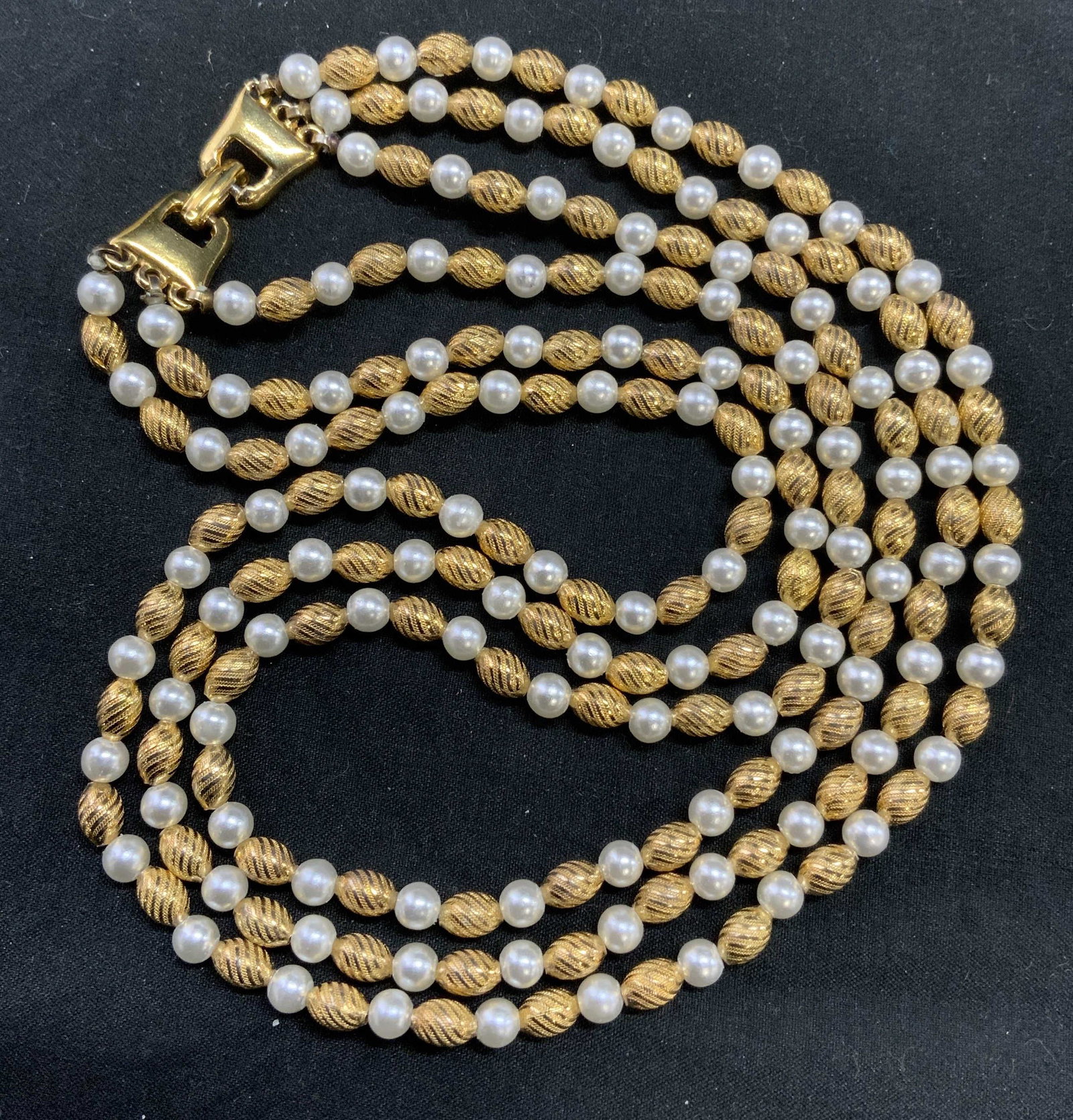 Vintage faux Pearl & Gold Tone Beaded Necklace: Vintage faux Pearl and embossed gold tone beaded 3 strand necklace with box clasp. Measures approx. 16 inches long. In good condition. Property of Palm Beach, Florida estate. Vintage jewelry, estate j