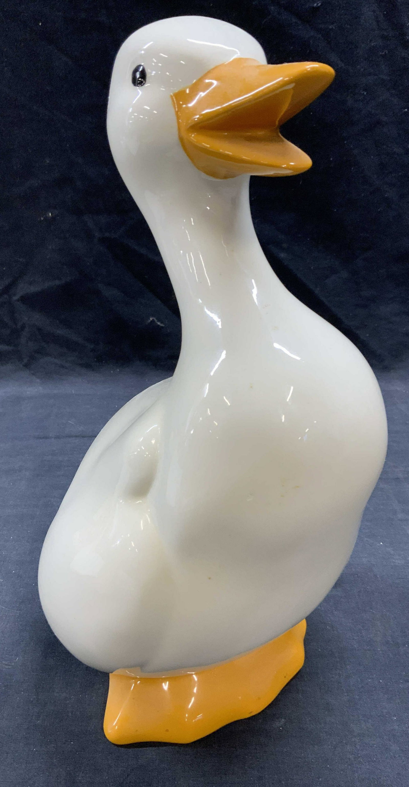 Vintage Porcelain Duck Statue: Duck statue is vintage and porcelain. Piece depicts a duck with beak open. Duck measures approx 12 inches tall 9 inches deep 6 inches wide. Duck statue, porcelain duck, porcelain duck statue, vintage 