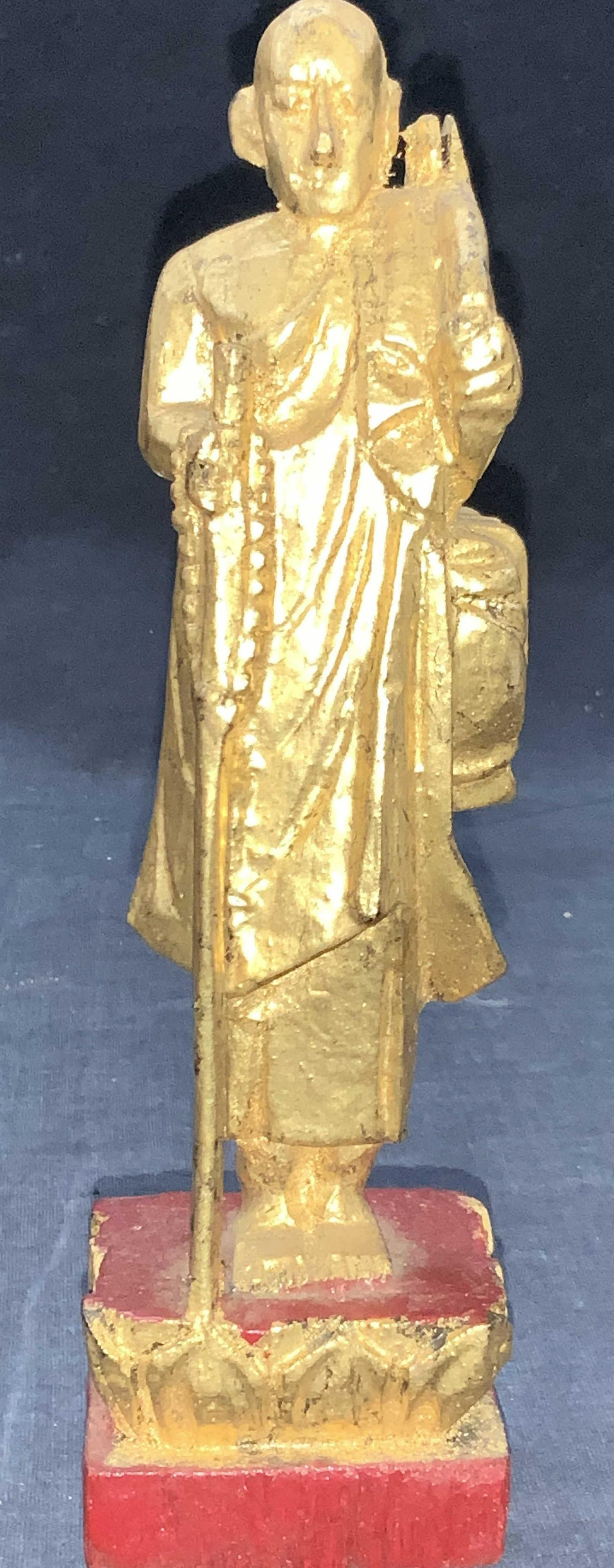 Vintage Carved Wooden Traveling Saint Buddha: Vintage carved wooden Figural. Depicting a gold painted Figural of Sivali, an arhat widely venerated among Theravada Buddhists. He is the patron saint of travel and is believed to ward off misfortunes
