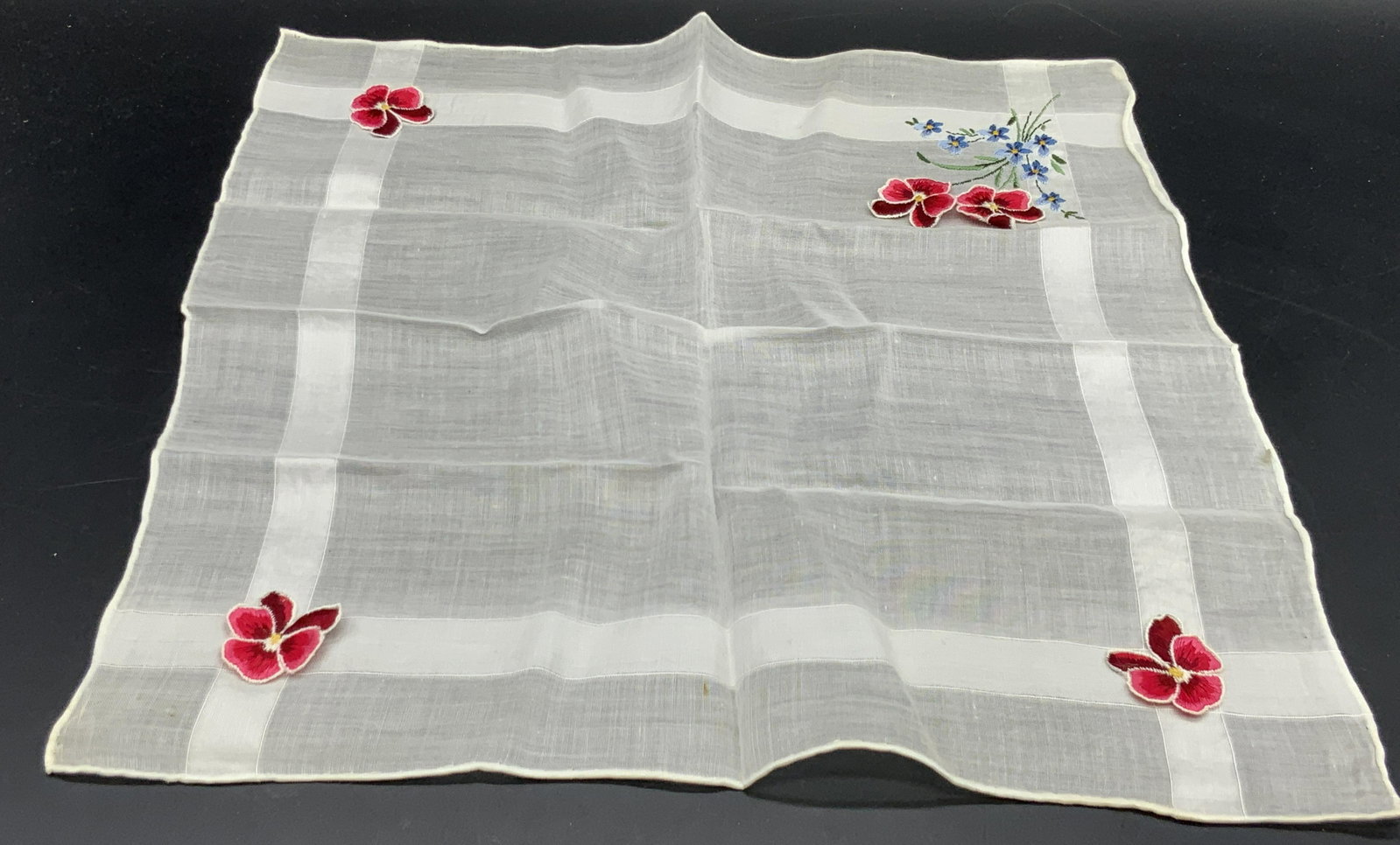 Vintage Floral Applique & Embroidery Handkerchief: A vintage soft hand, rolled edge handkerchief featuring colorful floral embroidery and applique. Soft hand, possibly silk or cotton or blend. No material tag present. Primarily white with red, blue, a