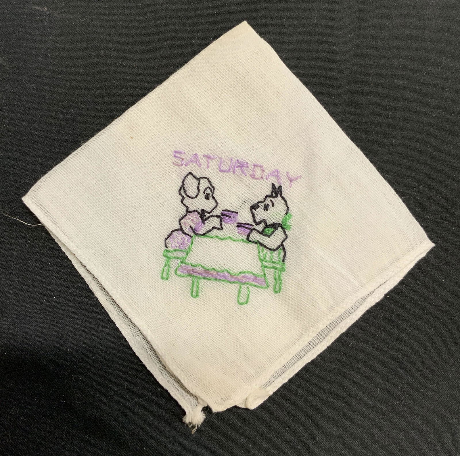 Vintage hand Embroidered Saturday Tea Hankie: Vintage hand embroidered Hankie with image of dogs drinking tea. Reads Saturday. Measures approx. 7.25 x 7 inches. Material feels like cotton. Some wear to fabric consistent with exposure. Hankie, han