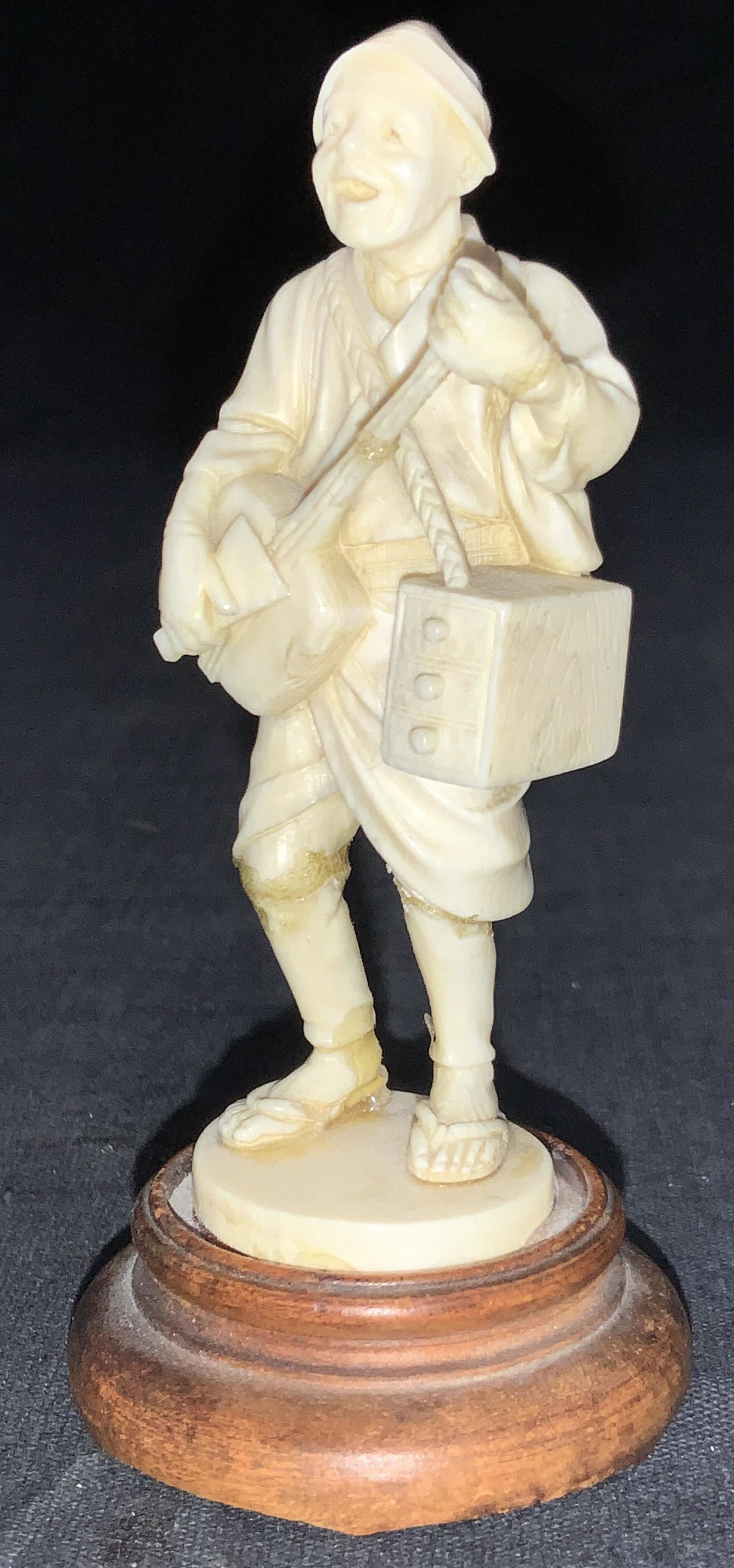 Japanese Man Singing Resin Figural: Resin Figural depicting a singing Japanese man with guitar in hand and a tiered box hanging under his arm. Approximately 3.5 inches tall. Evident wearing and repairs to figure. Asian decor, Japanese d