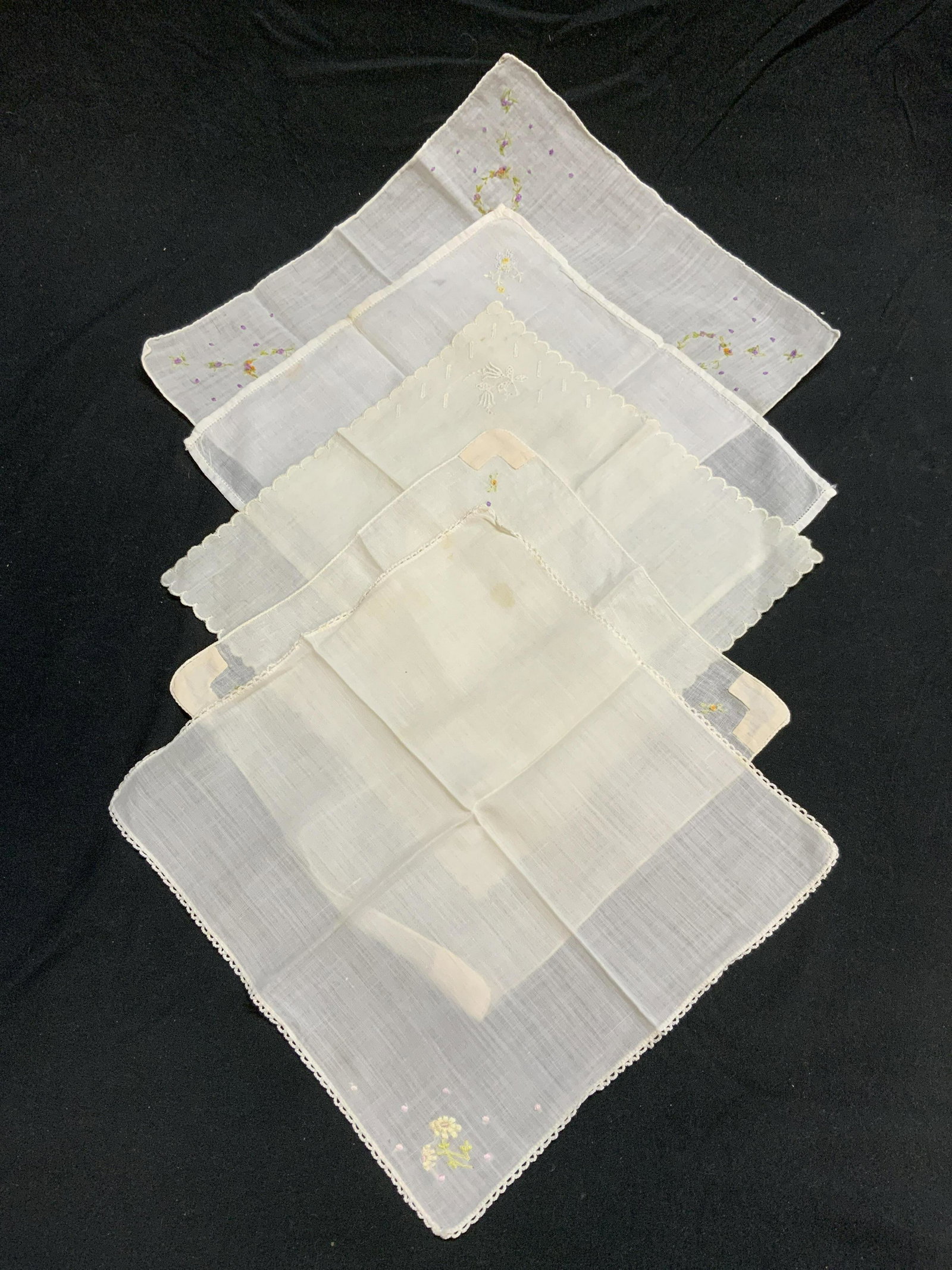Group 5 Vtg White Embroidered Handkerchiefs: Group of 5 vintage white handkerchiefs with embroidered decoration. Sizes vary, largest approx. 10 x 11.5 inches. All pieces have some wear to fabric consistent with exposure. Materials feels like cot
