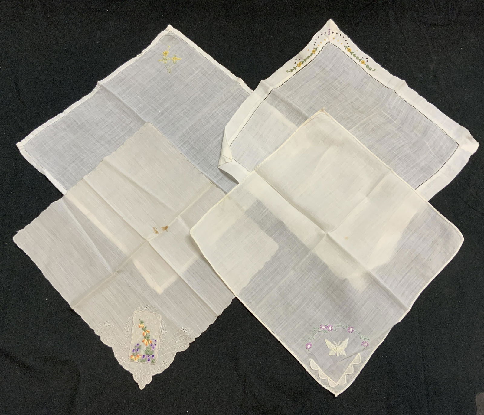 Group 4 Vtg White Embroidered Handkerchiefs: Group of 4 vintage white handkerchiefs with embroidered decoration. Sizes vary, largest approx. 10 x 10 inches. All pieces have some wear to fabric consistent with exposure. Materials feel like cotton