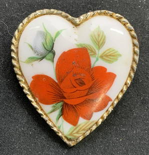 Vintage Enamel Floral Heart Pendant Brooch: Vintage gold tone heart pendant brooch with floral motif. Hook for stringing on necklace to underside. Hinge pin backing. Surface wear consistent with exposure. Measures approx. 1.5 x 1.5 inches. Prop