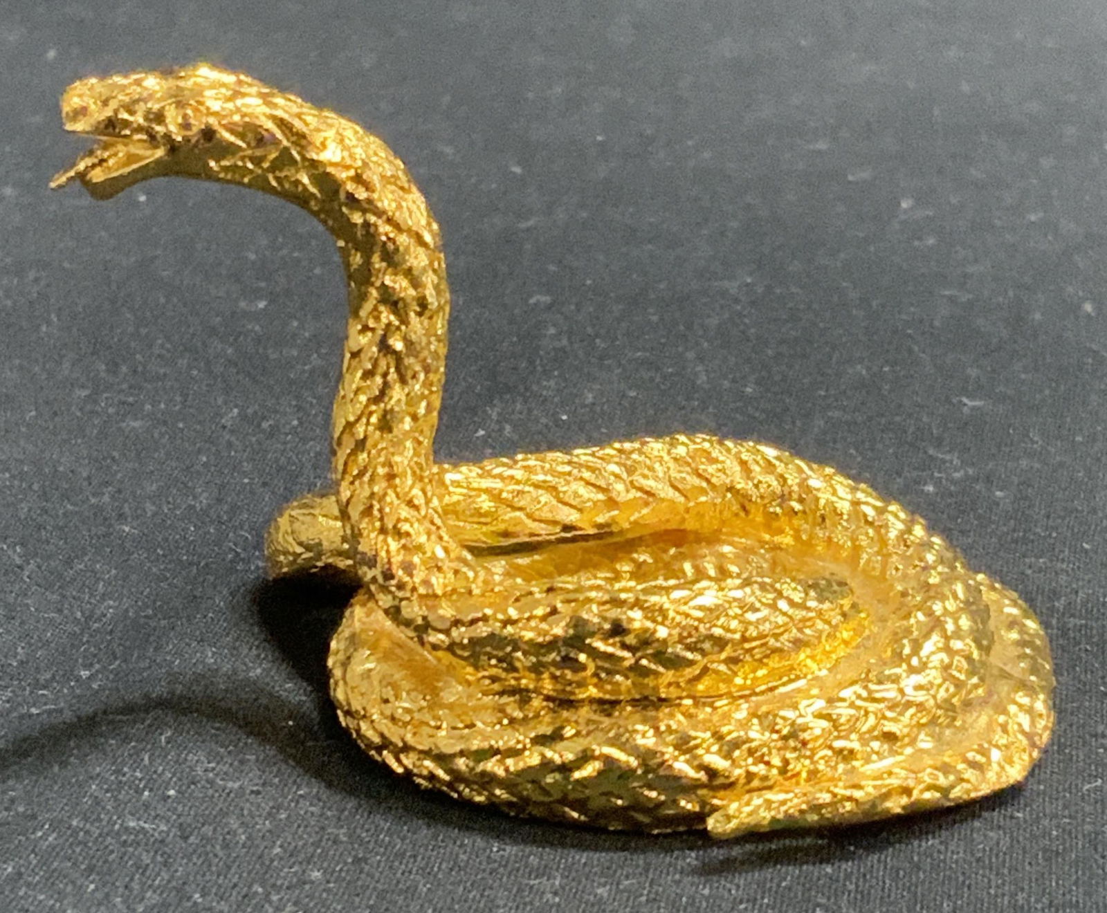 Gold Tone Miniature Snake Figurine: Gold tone miniature snake figurine. Measures approx. 2 x 1.5 x 1.5 inches. In good condition. Marked to underside, illegible. Snake figurine, gold tone snake, miniature figurine, snake, table decor, t