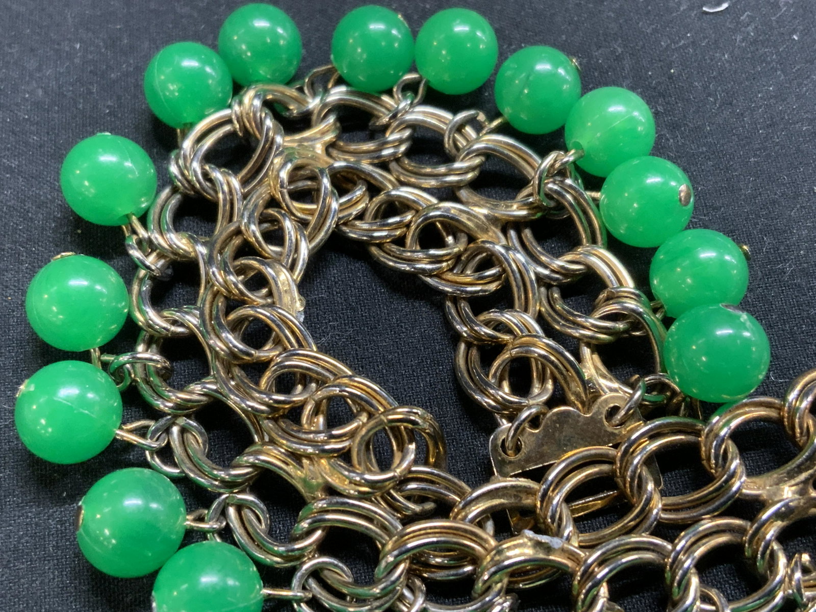 LISA Green Beaded Dangle Bracelet, Jewelry: Signed Lisa green beaded dangle chain bracelet with box clasp. Designer label to jewelry charm. Measures approx. 6.75 inches long. Some surface wear consistent with exposure. Lisa jewelry, estate jewe