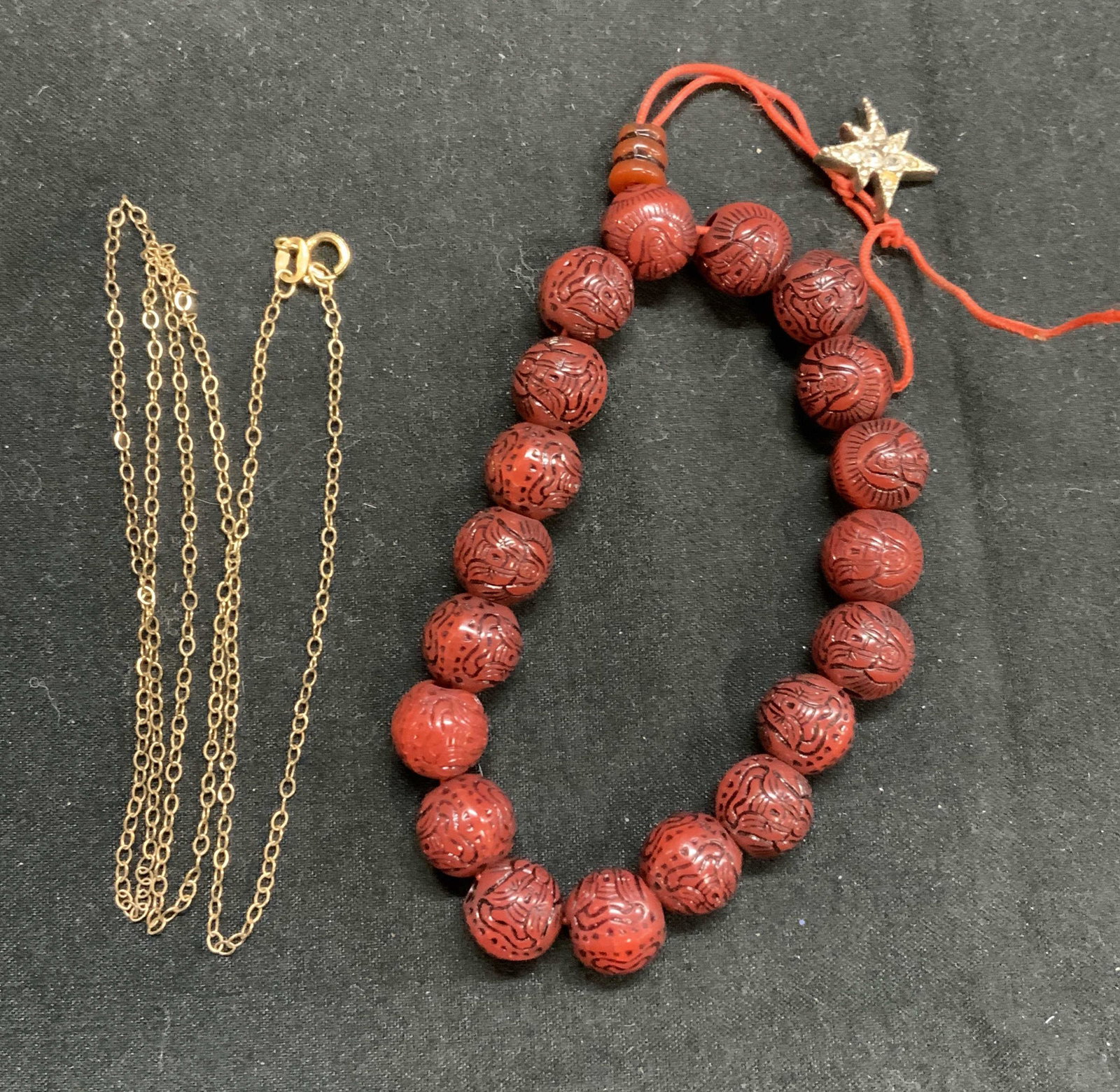 14 KGF Choker & Sterling Slv Charm Bracelet: 14 k golf filled choker necklace. Marked 14 K GF to necklace charm. Measures approx, 18 inches long. Carved Buddha red resin beaded bracelet with sterling silver star charm and crystal decoration. Hal