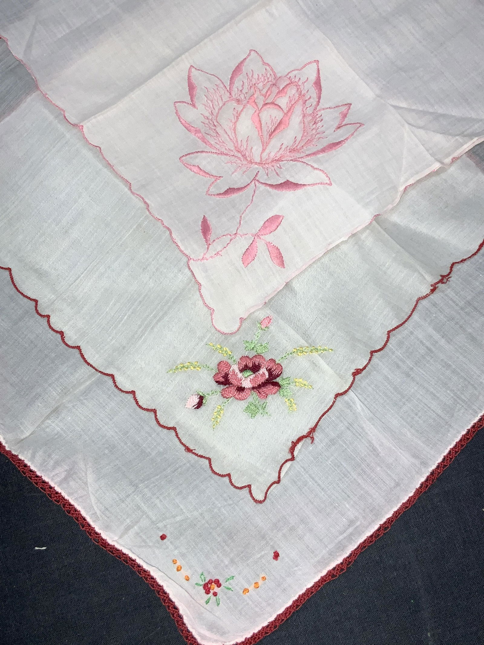 3 Vintage Embroidered Linens Handkerchiefs: 3 vintage linen handkerchiefs. 1 with woven red edges and embroidered red and orange flowers in the corners. 1 handkerchief with scalloped edges in red with embroidered pink rose in corner. And 1 pink