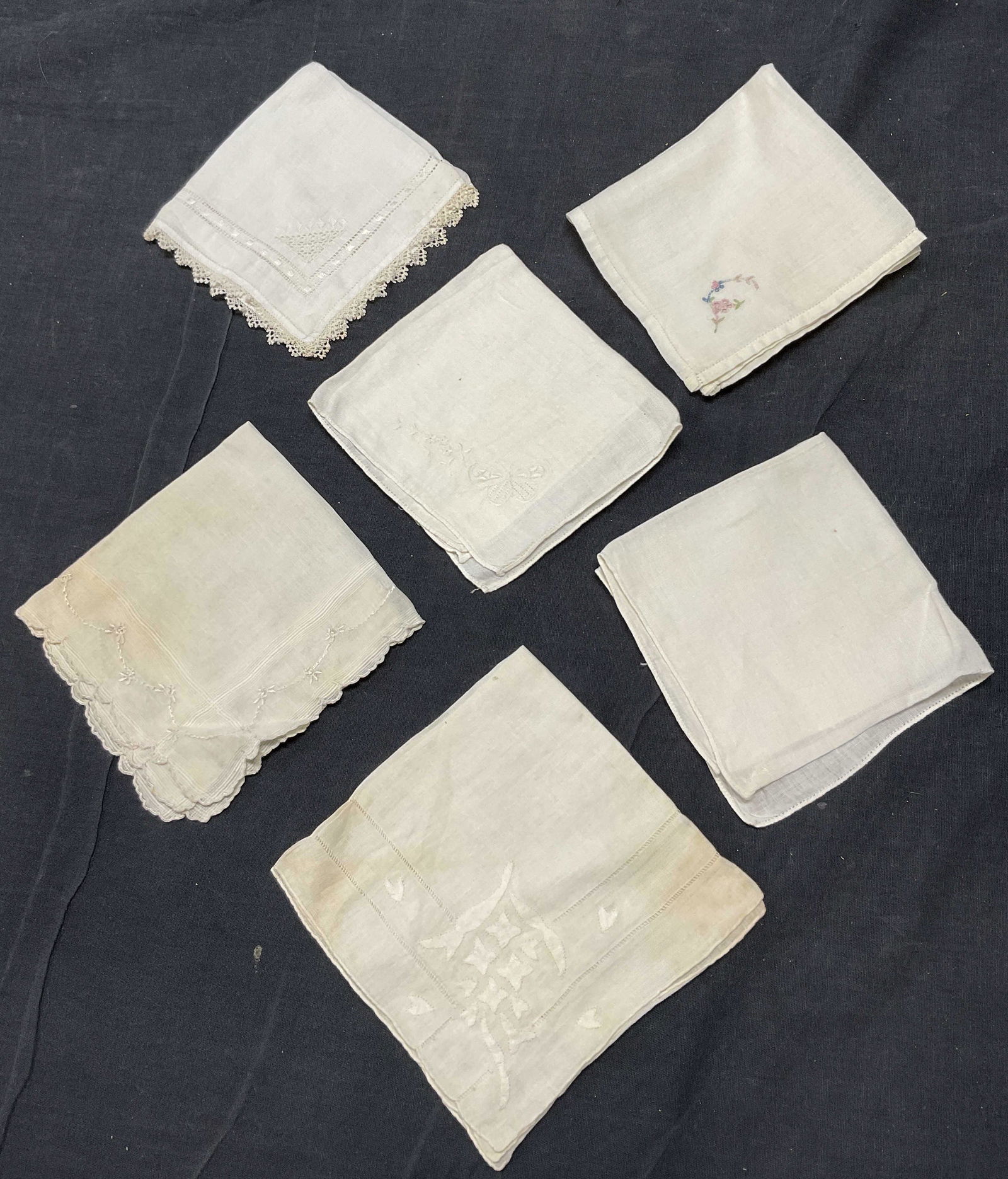 Lot 6 White Embroidered Handkerchiefs: Lot 6 White Embroidered Handkerchiefs. Significant staining to pieces and minor wearing to fabric (see photos). Largest measures 11.25 x 11.25. Hand rolled edges. Up cycle fabrics, handkerchiefs, embr