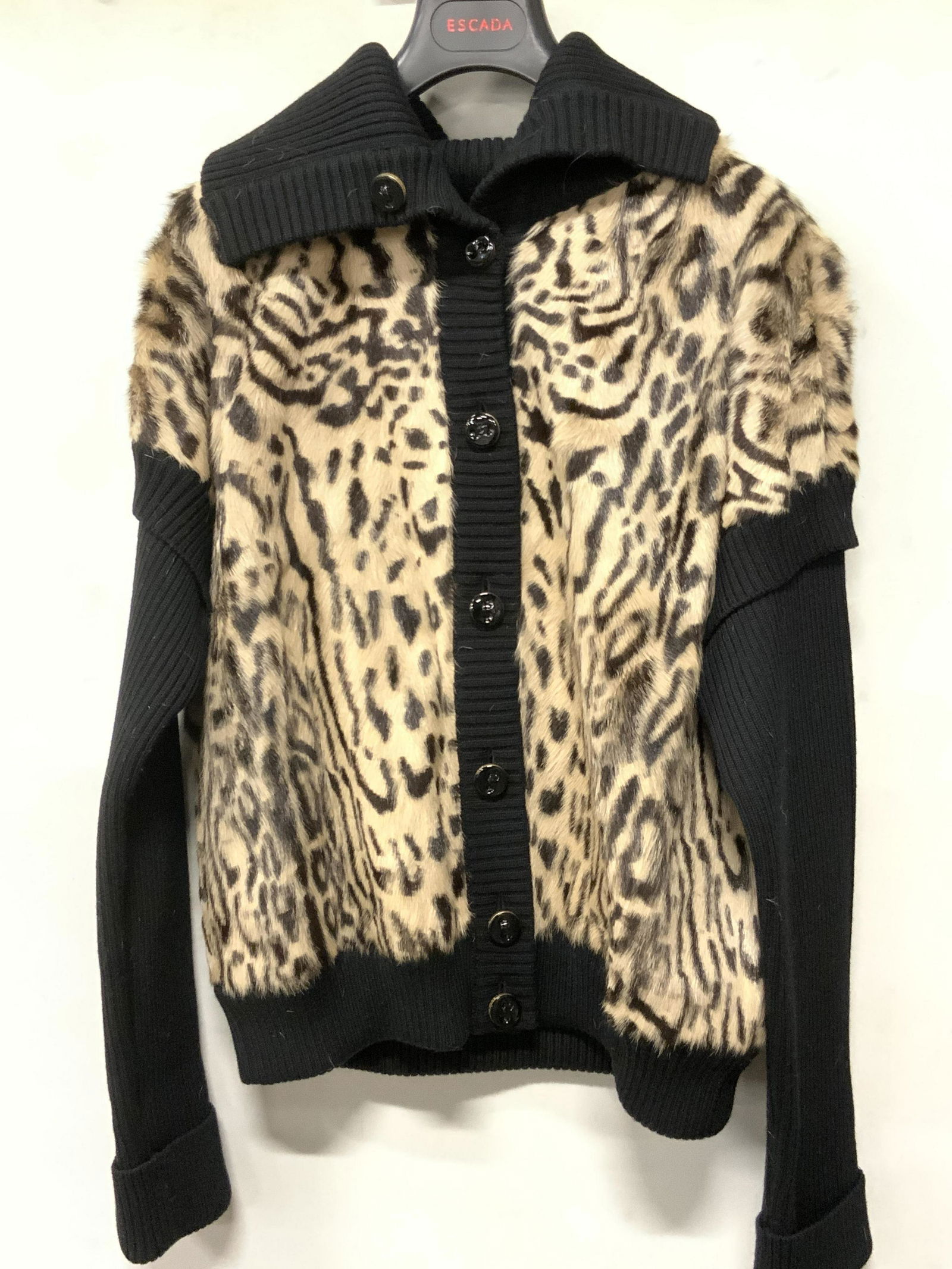 ESCADA Italian Dyed Leopard Style Fur Sweater: A black button-up sweater with dyed fur across the obverse and reverse. Leopard style motif along the fur. Interior is lined with a black soft hand fabric. Interior tag reads ESCADA, 44, Made in Italy