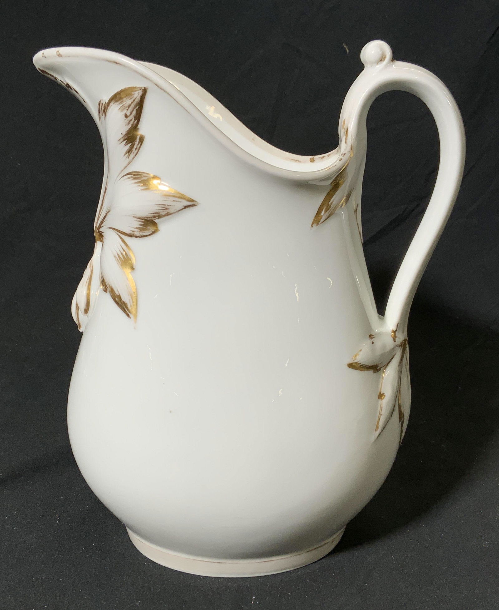 Gilt Porcelain Floral Pitcher: Gilt porcelain floral pitcher. Measures approx. 8 x 5.5 x 9.5 inches. Some loss to paint. Pitcher, porcelain pitcher, floral pitcher, gilt porcelain, porcelainware, tableware, table accessories, home