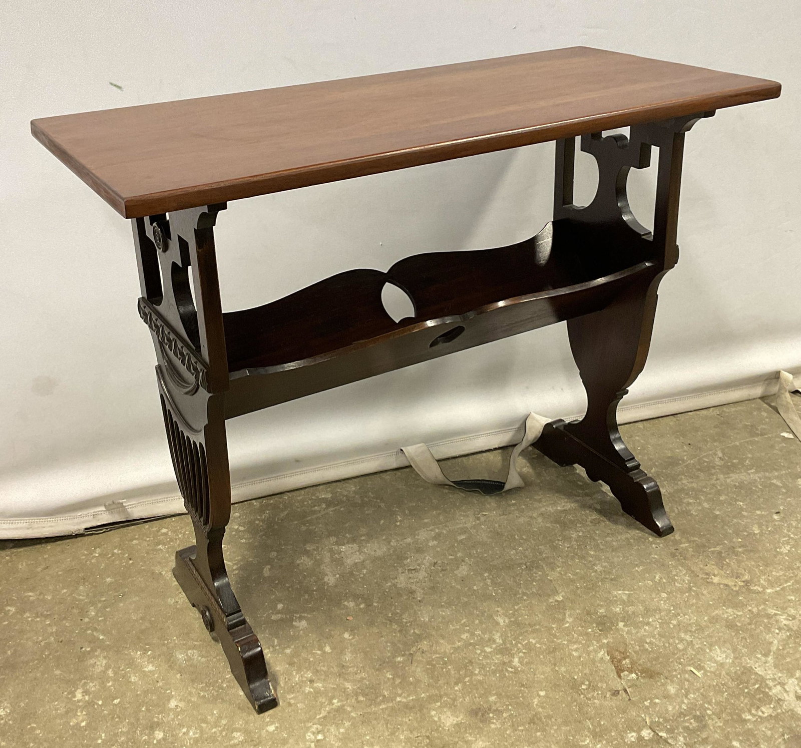 Carved Wood Magazine Stand / Console: Carved Wood Magazine Stand / Console. Measures approx 30 x 14 x 24 inches. Some significant wear to surface consists of scratches and some chipping (see photos). Post mahogany woods. Home wares, furni