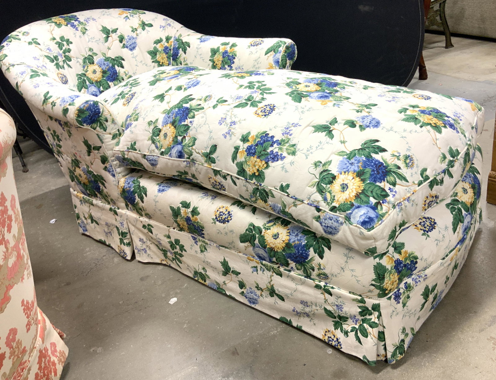 Vintage Skirted Floral Detailed Chaise Lounge: Chaise lounge is vintage. Piece has barrel shaped back rest and is skirted. Chaise has intricate multi toned floral and leaf detail. Piece has loose cushion. Piece measures approx 67 inches long 35 in