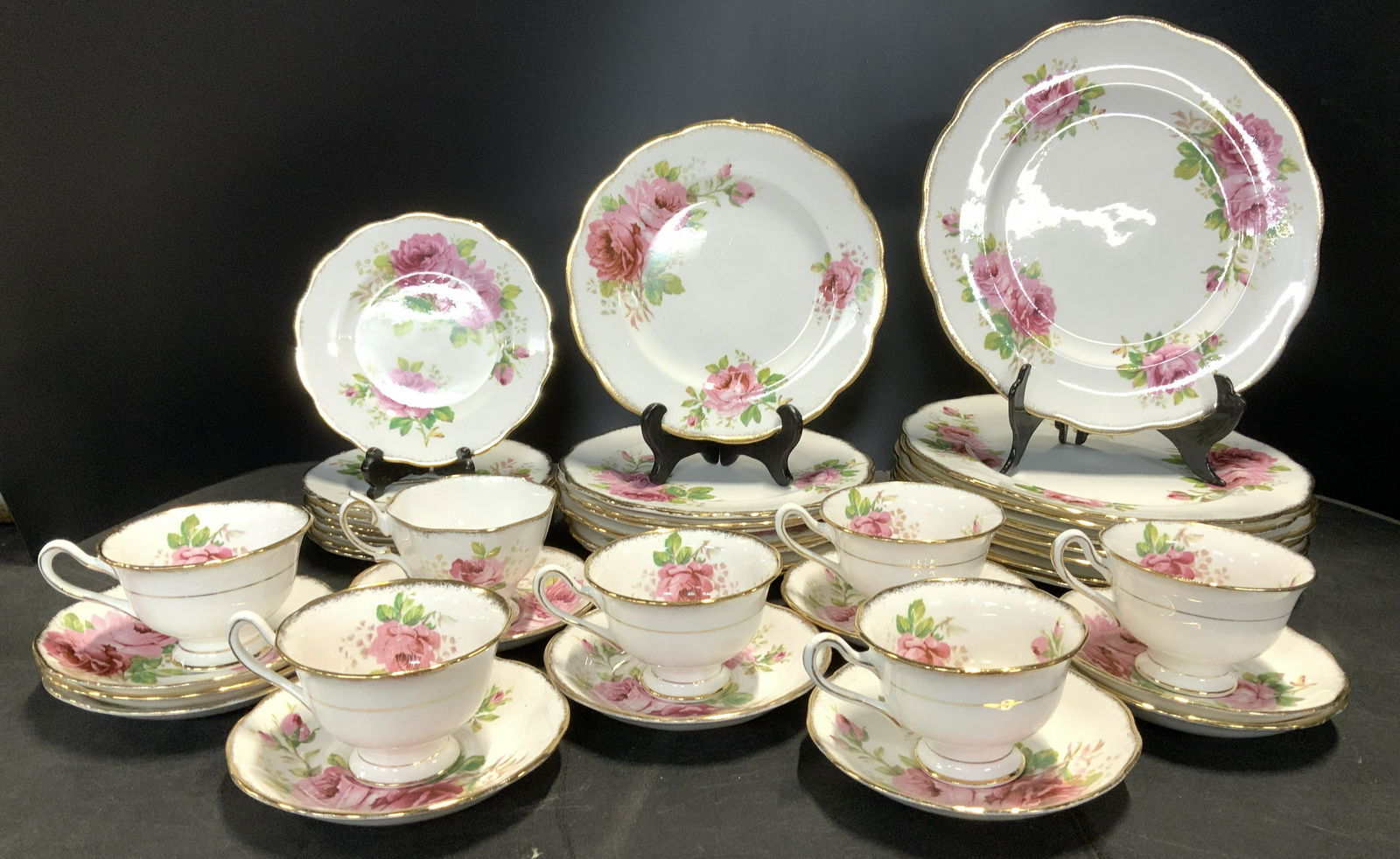 Set 35 Royal Albert American Beauty Chinaware: Fine bone English chinaware, white porcelain with hand painted pink roses and edge gilt. Royal Albert American Beauty pattern. Set includes 8 Dinner plates , 10.25 in. , 8 luncheon plates 7.75 in. 8 d