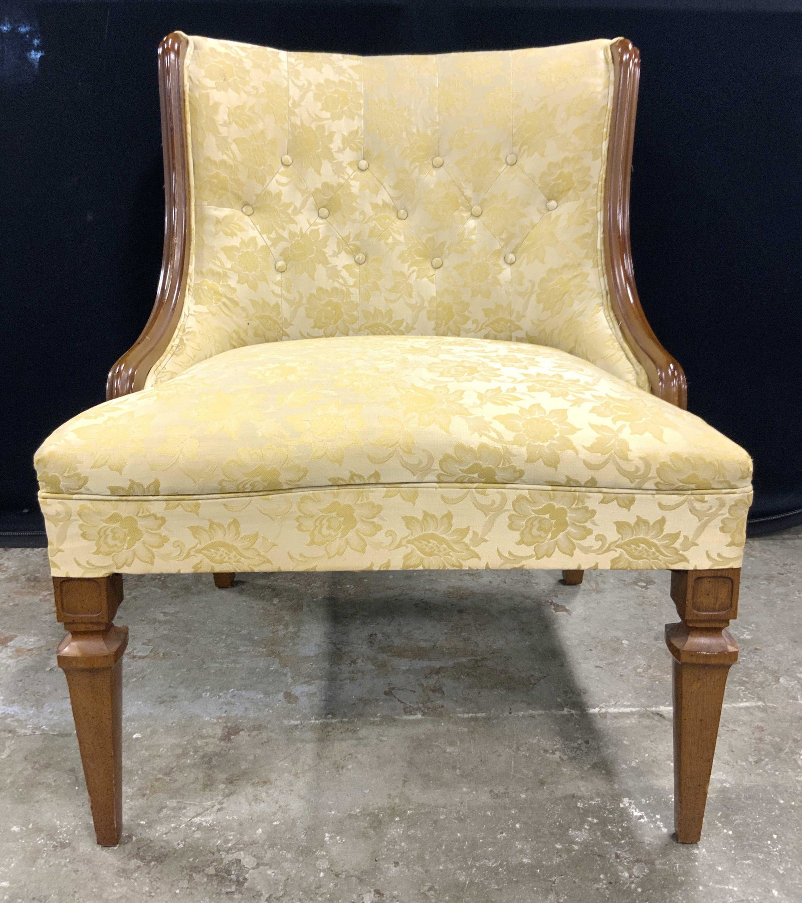 Hand Carved Vintage Upholstered Tufted Chair: Chair is vintage possibly antique. Piece has Gold toned floral & leaf detailed upholstery. Piece has 4 carved wooden legs & sides. Some Edges of upholstery have double welting. Backrest is tufted. Pie