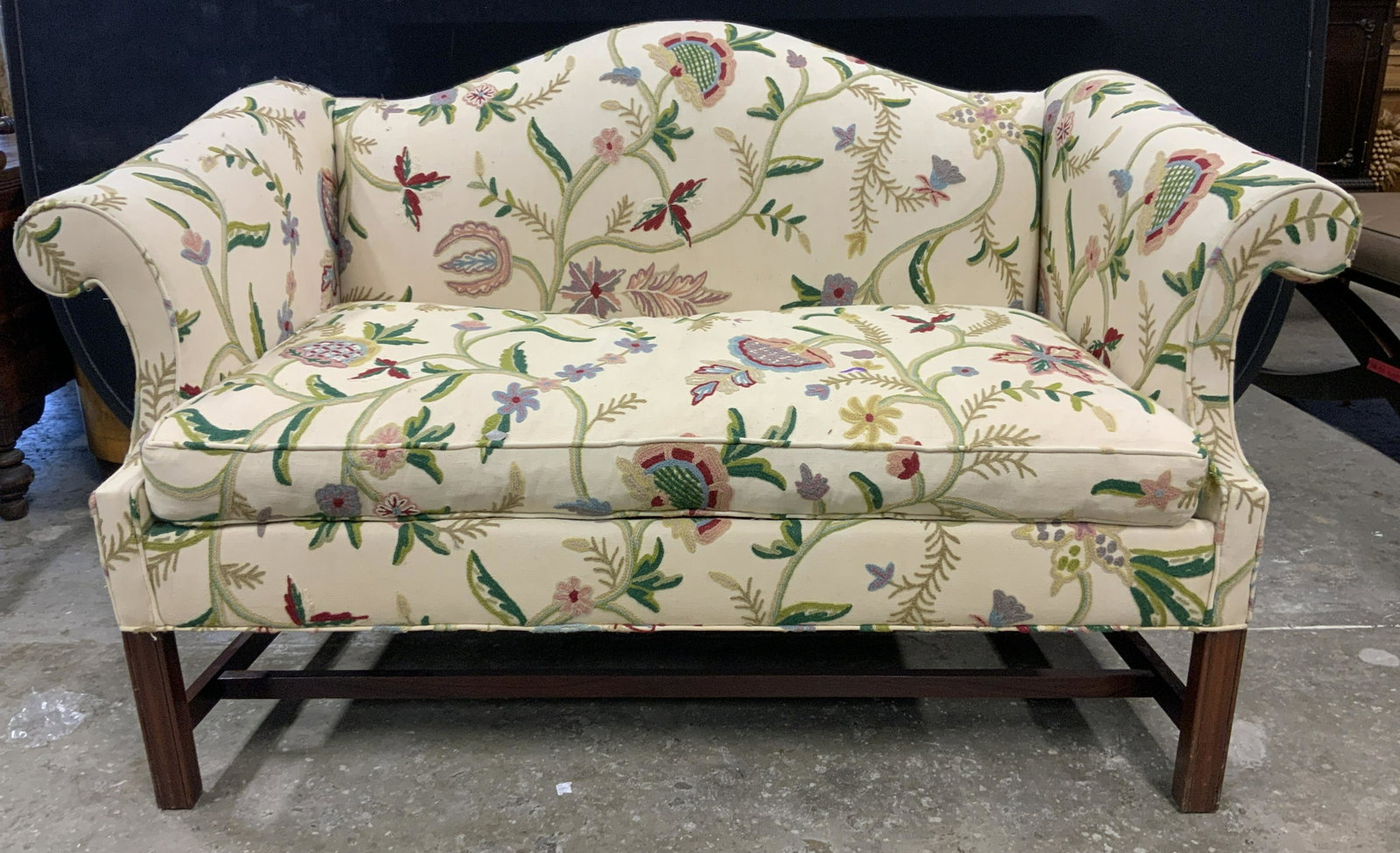 W&J SLOANE INC CREWEL Embroidered Loveseat: Tag underneath cushion reads W&J SLOANE INC. Loveseat is cream yellow with intricate multi toned crewel embroidery. Piece has wooden legs with stretchers in between. Piece measures approx 58 inches lo